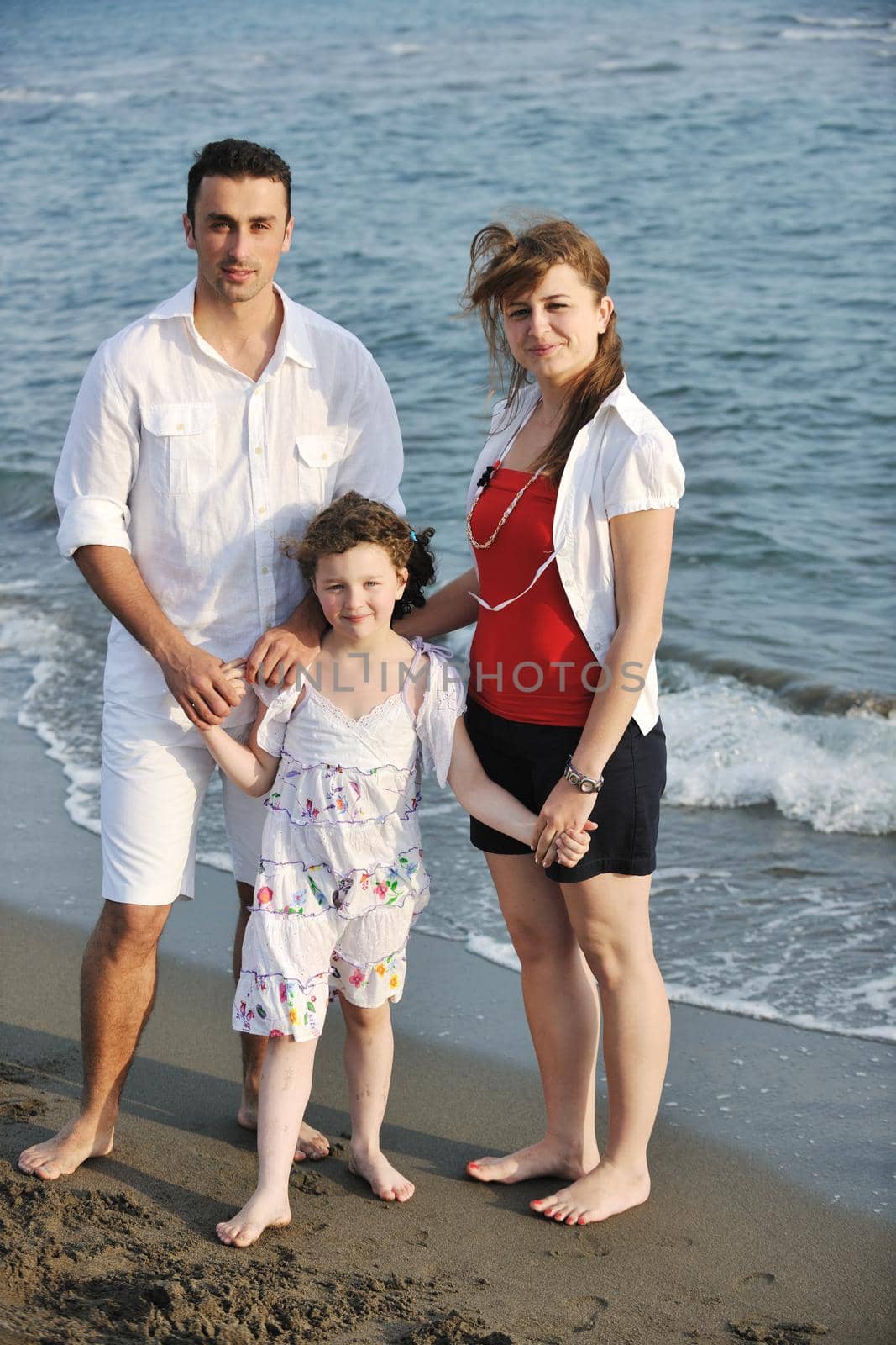 happy young family have fun and live healthy lifestyle on beach