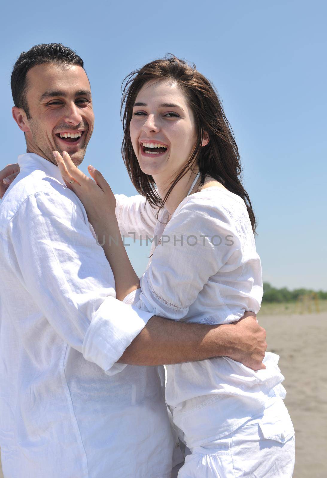 happy young couple have fun and romantic moments on beach at summer season and representing happynes and travel concept