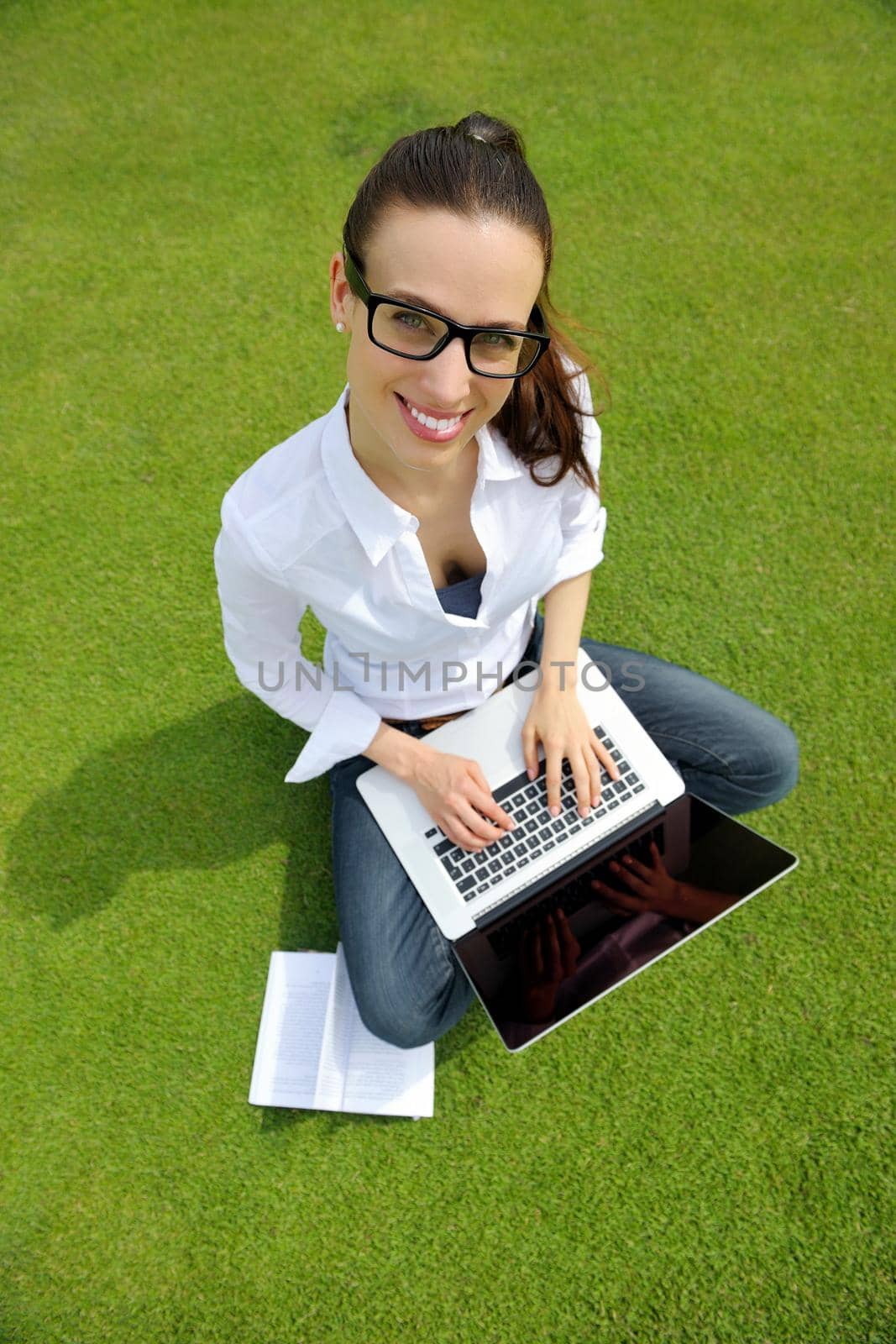 happy young student woman with laptop in city park study