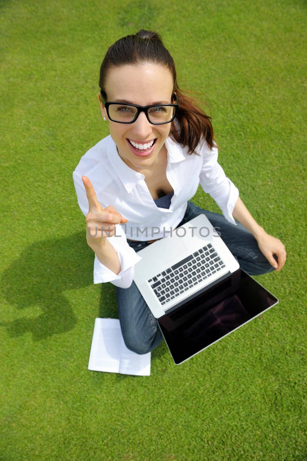 happy young student woman with laptop in city park study