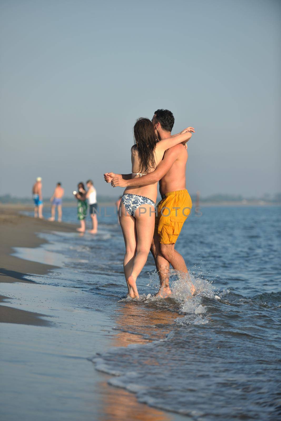 happy young couple have fun and romantic moments on beach at summer season and representing happynes and travel concept