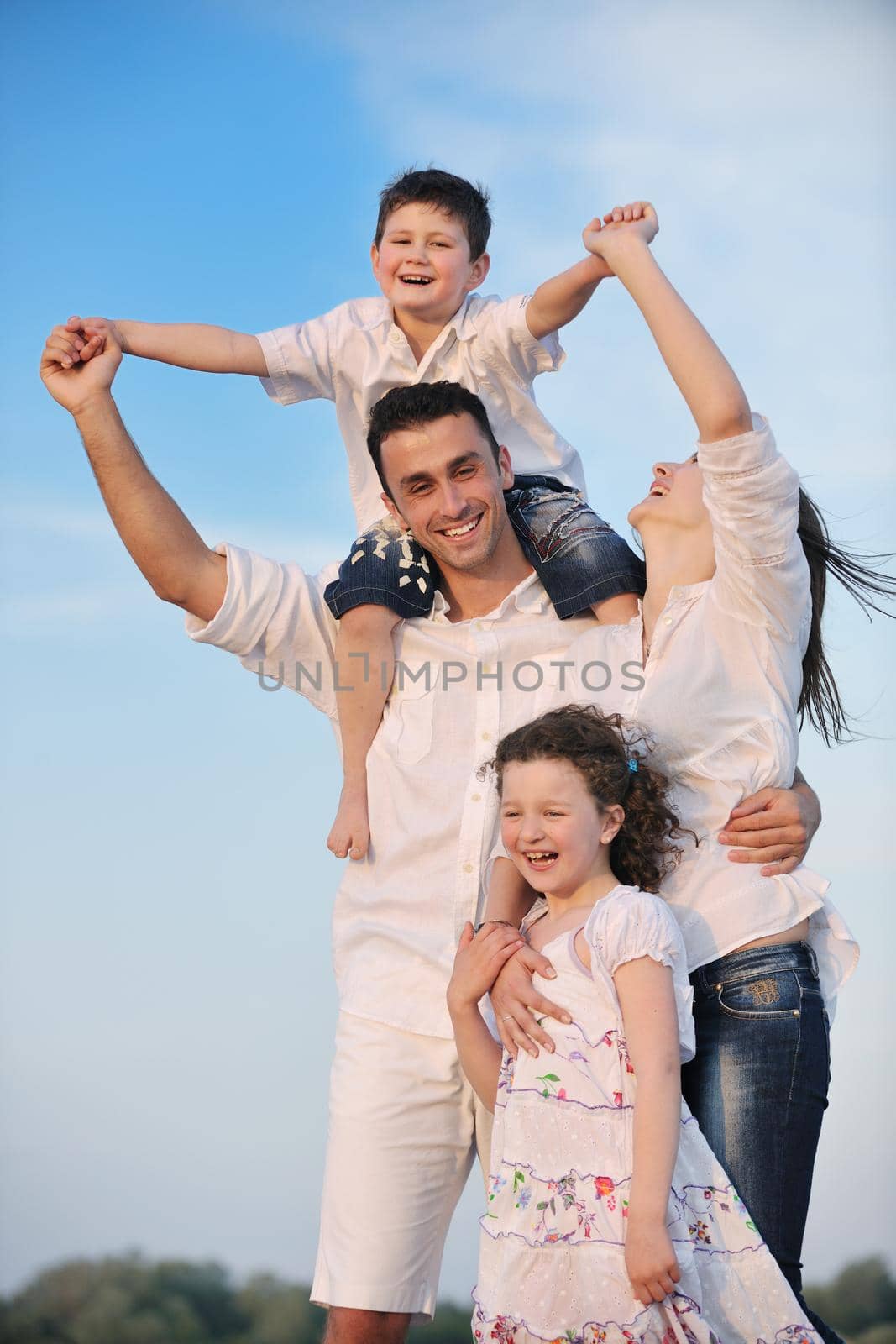 happy young family have fun and live healthy lifestyle on beach