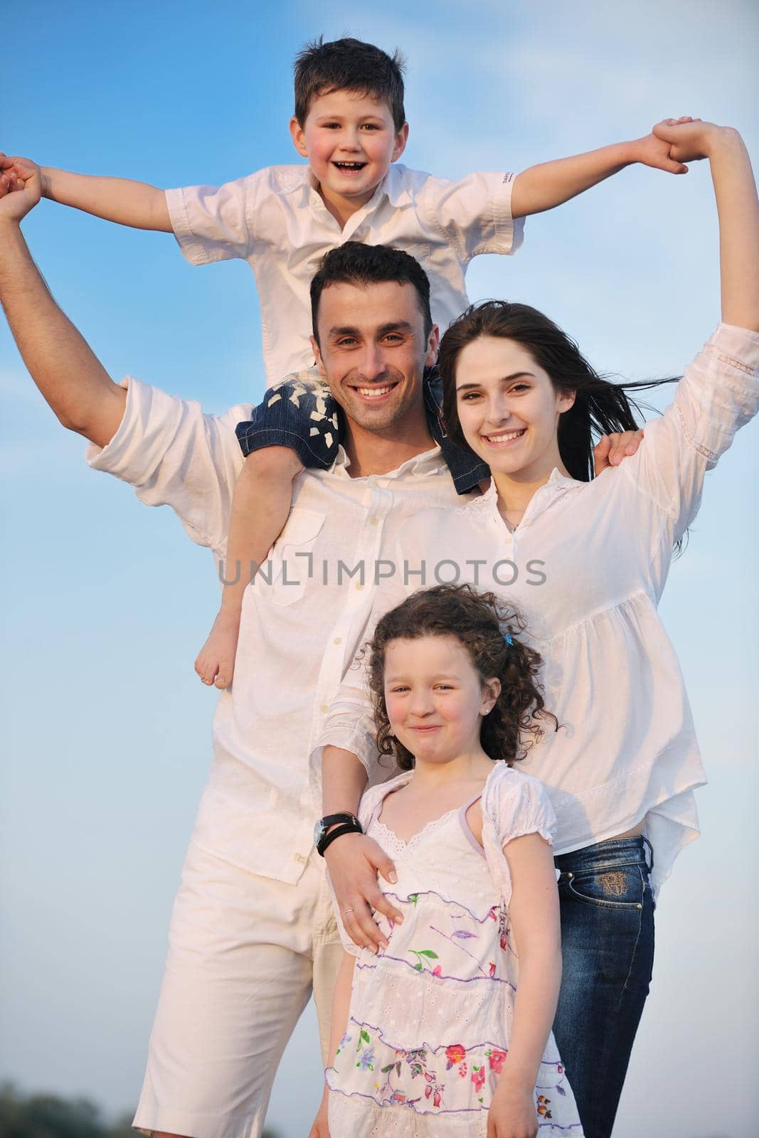 happy young family have fun and live healthy lifestyle on beach