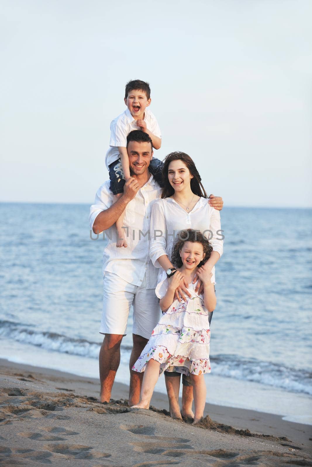 happy young family have fun and live healthy lifestyle on beach