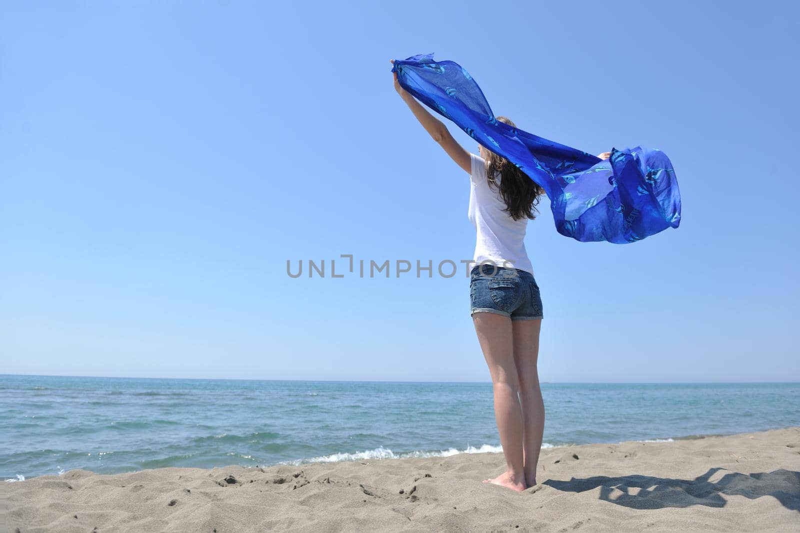 beautiful young woman on beach with scarf relax smile and have fun