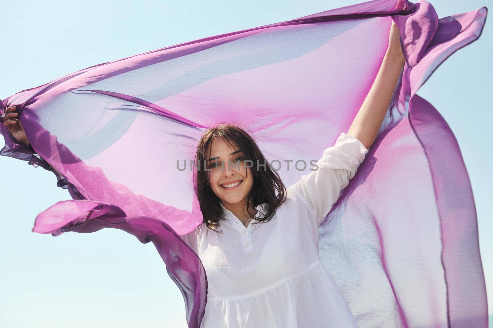 beautiful young woman on beach with scarf relax smile and have fun