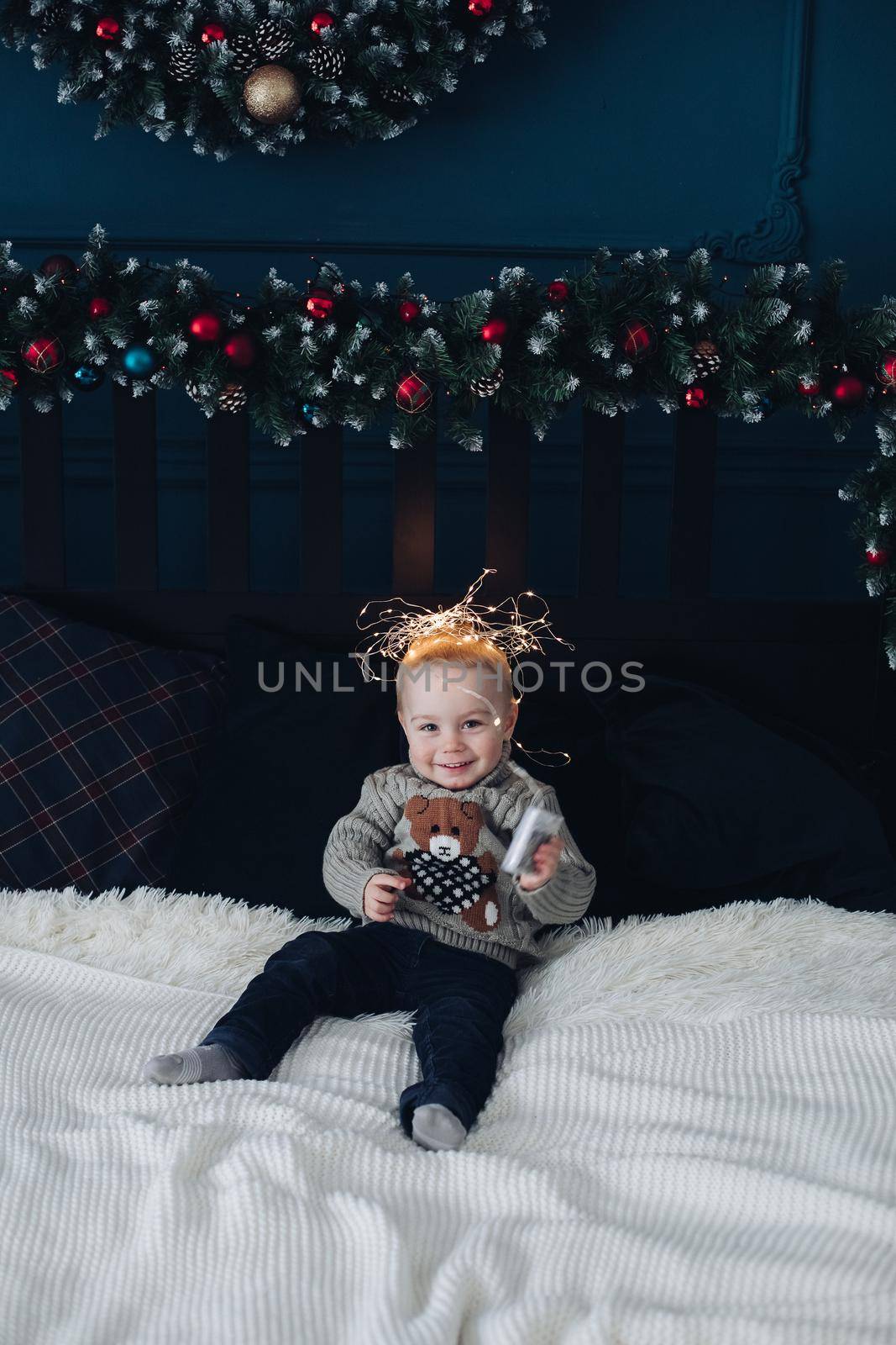 Cute boy with garland on head. by StudioLucky