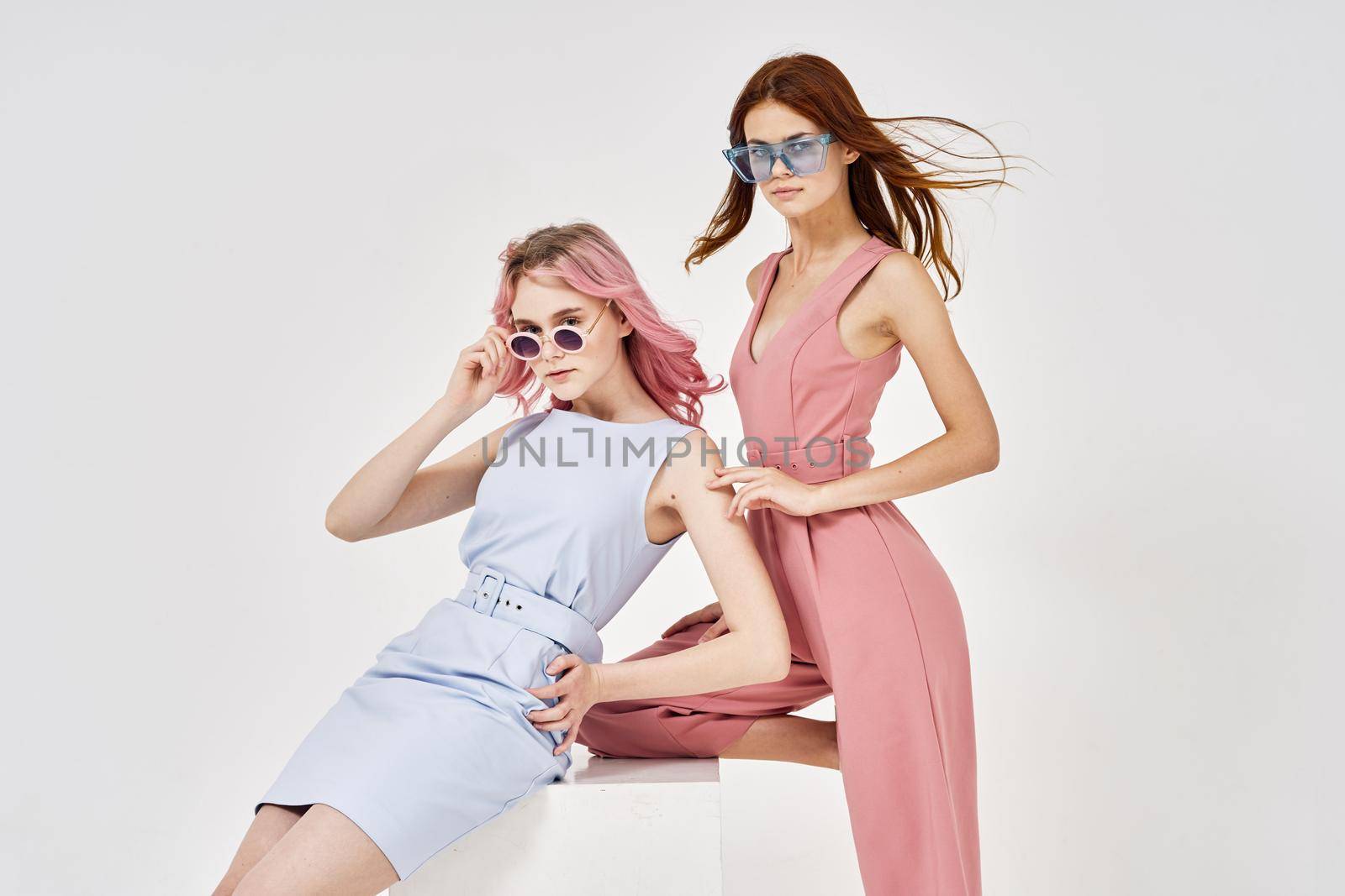 two girlfriends stand side by side fashion clothing glamor posing by Vichizh