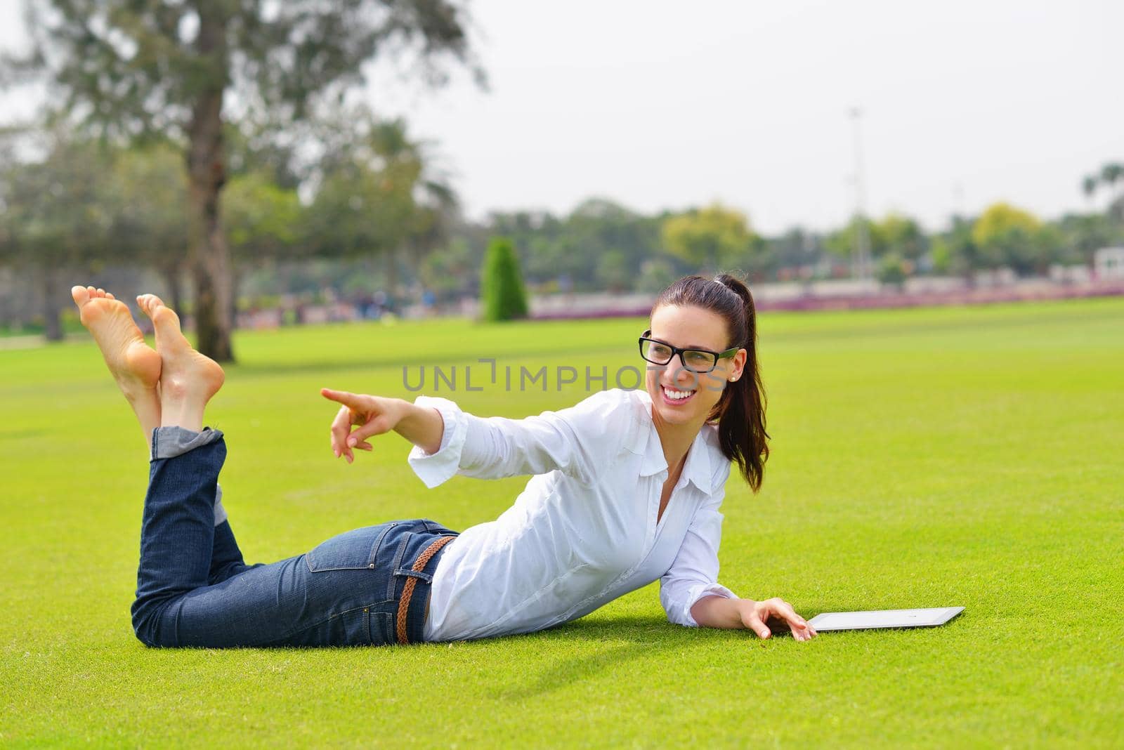 Beautiful young student  woman study with tablet in park