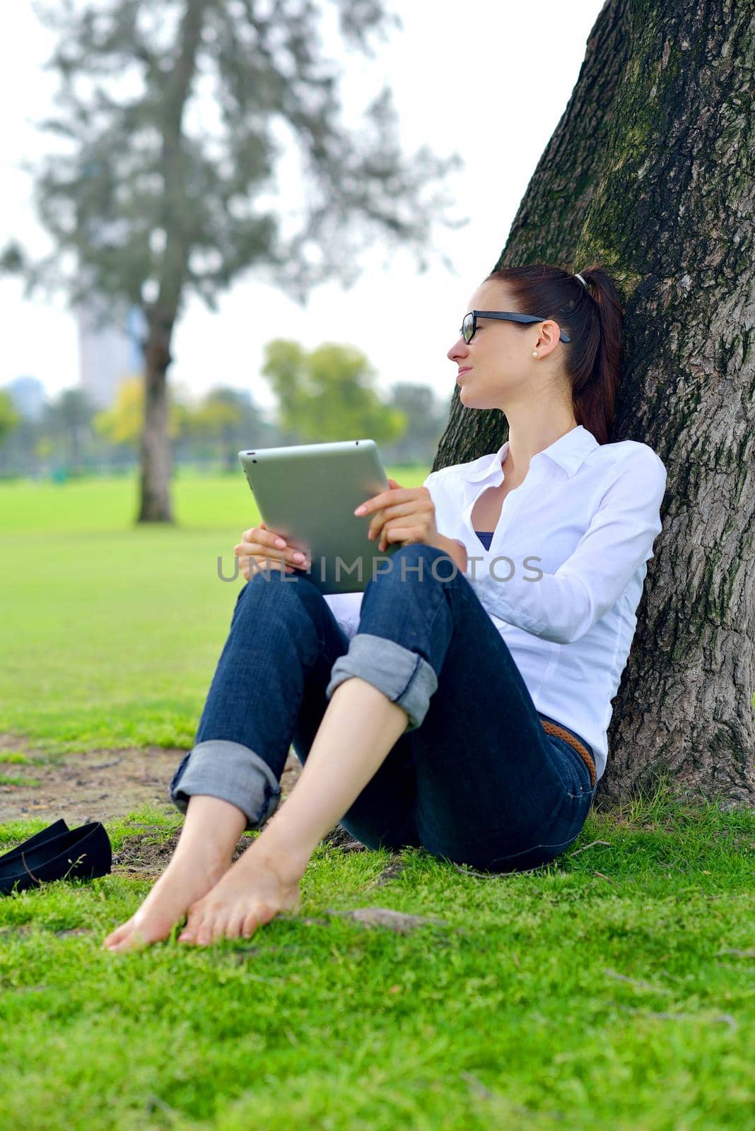 Beautiful young student  woman study with tablet in park