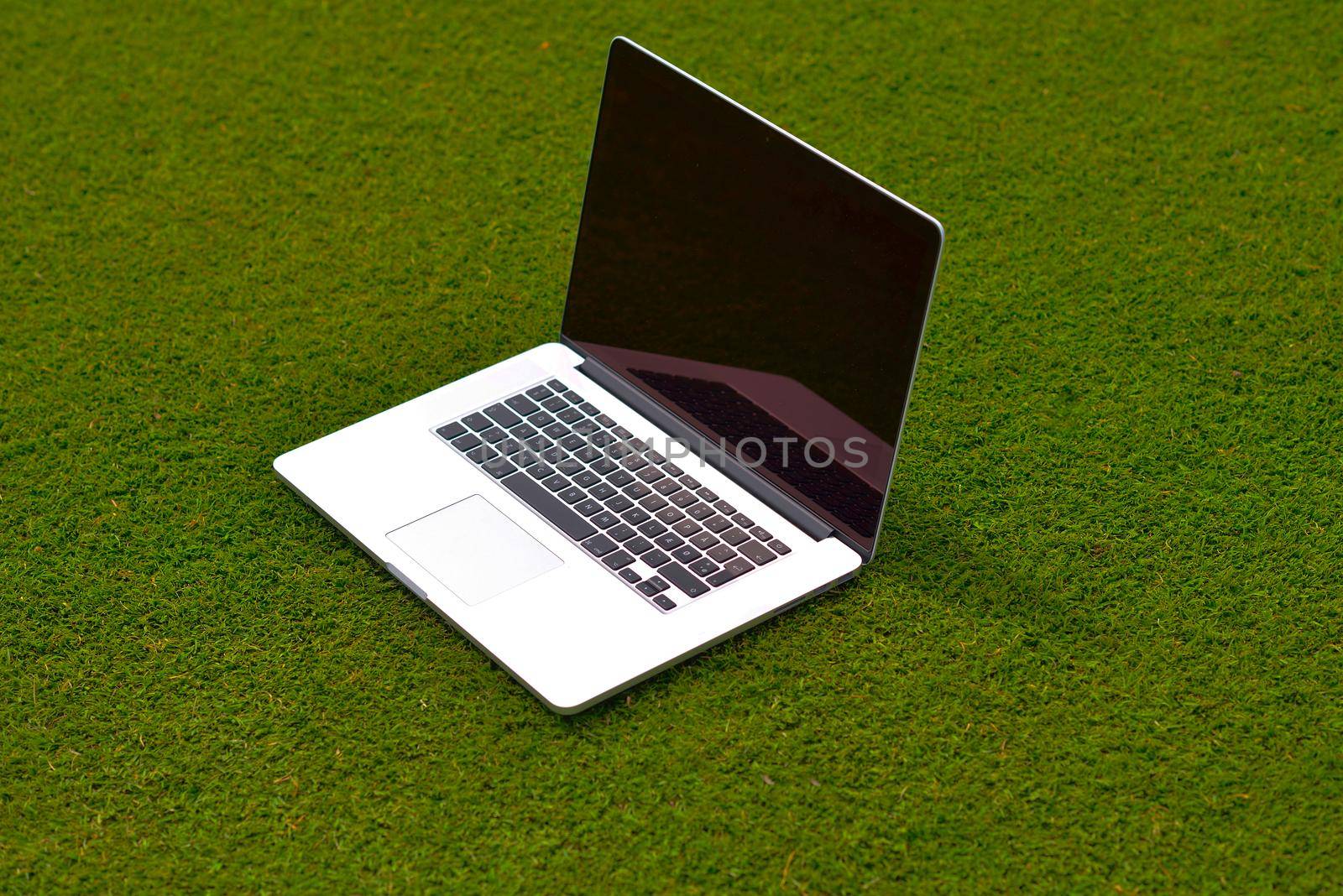 laptop computer  on grass by dotshock