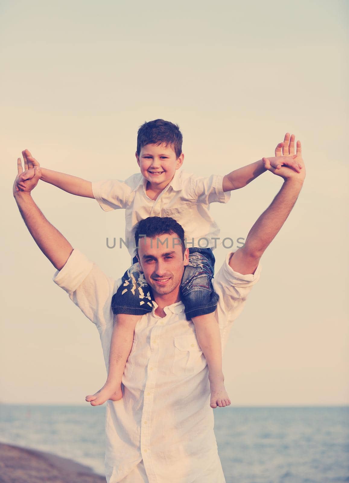 happy young family have fun on beach by dotshock