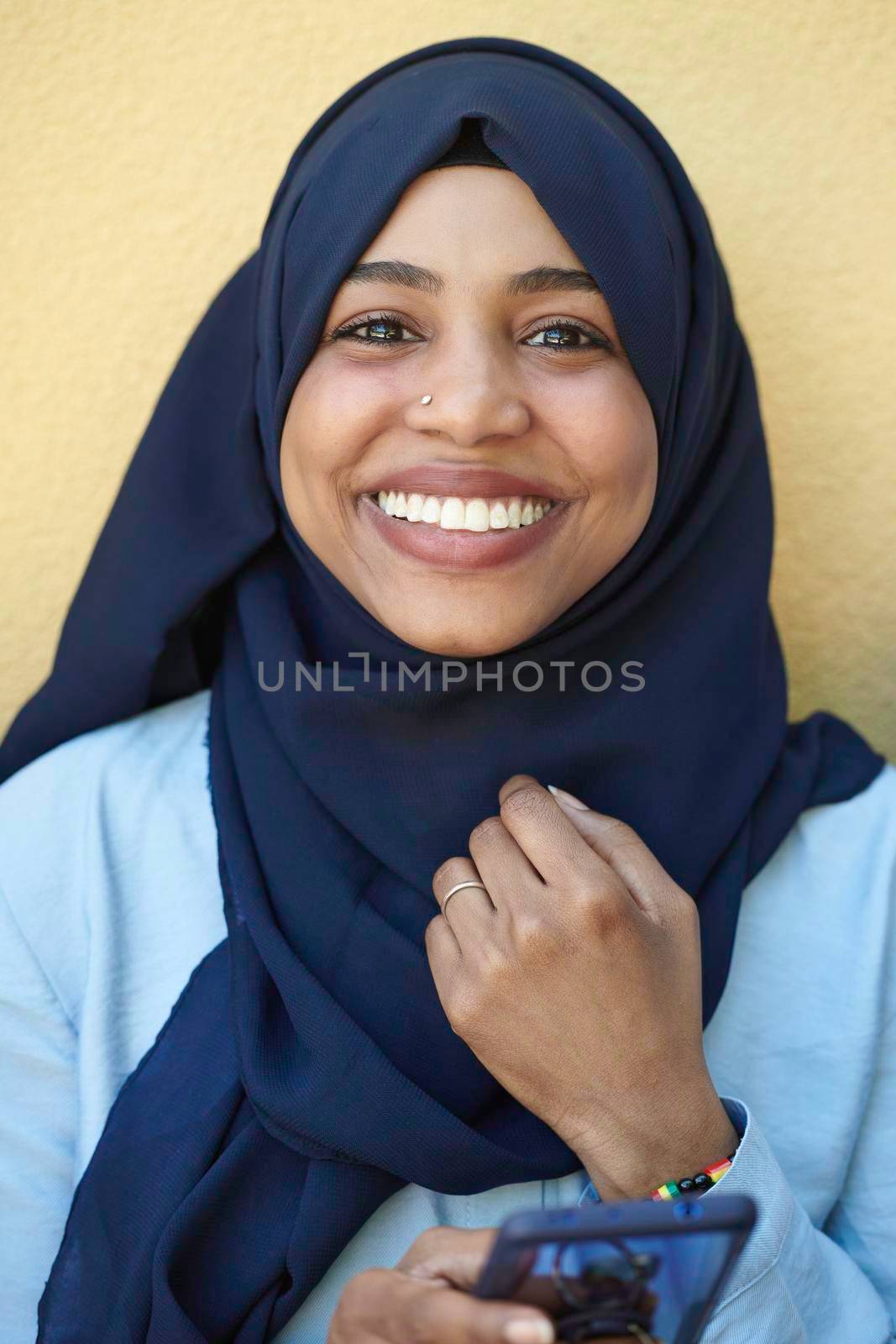 african  business woman using smart phone wearing traditional islamic clothes