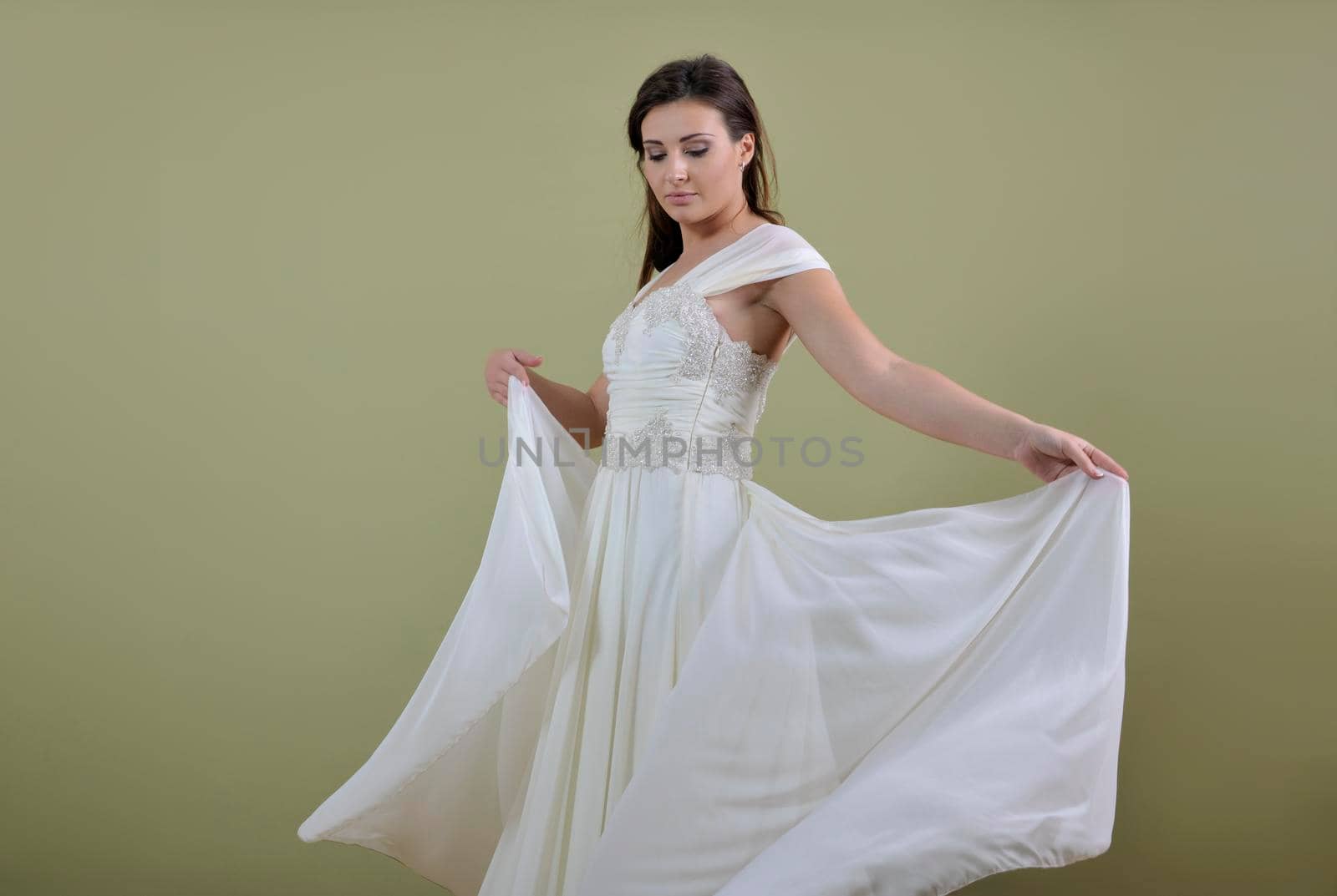 Portrait of a beautiful woman dressed as a bride isolated on white background in studio