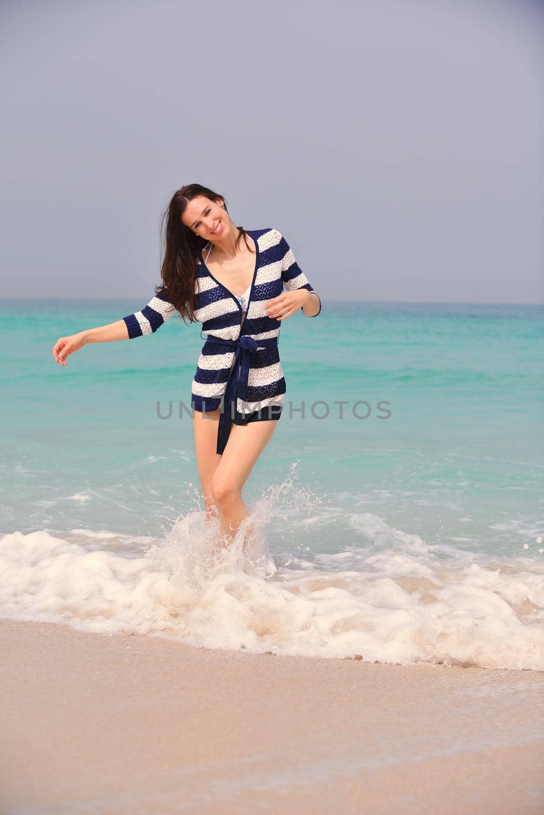 Happy Beautiful Woman Enjoying Summer Vacation on beach