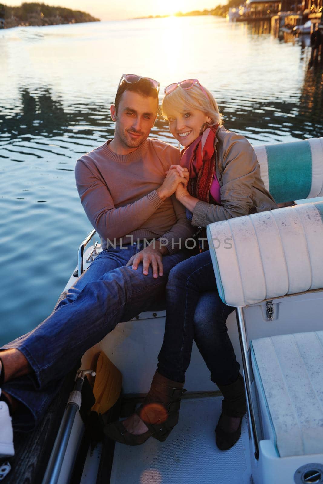 happy young couple in love  have romantic time at summer sunset   at ship boat while  representing urban and countryside fashin lifestyle