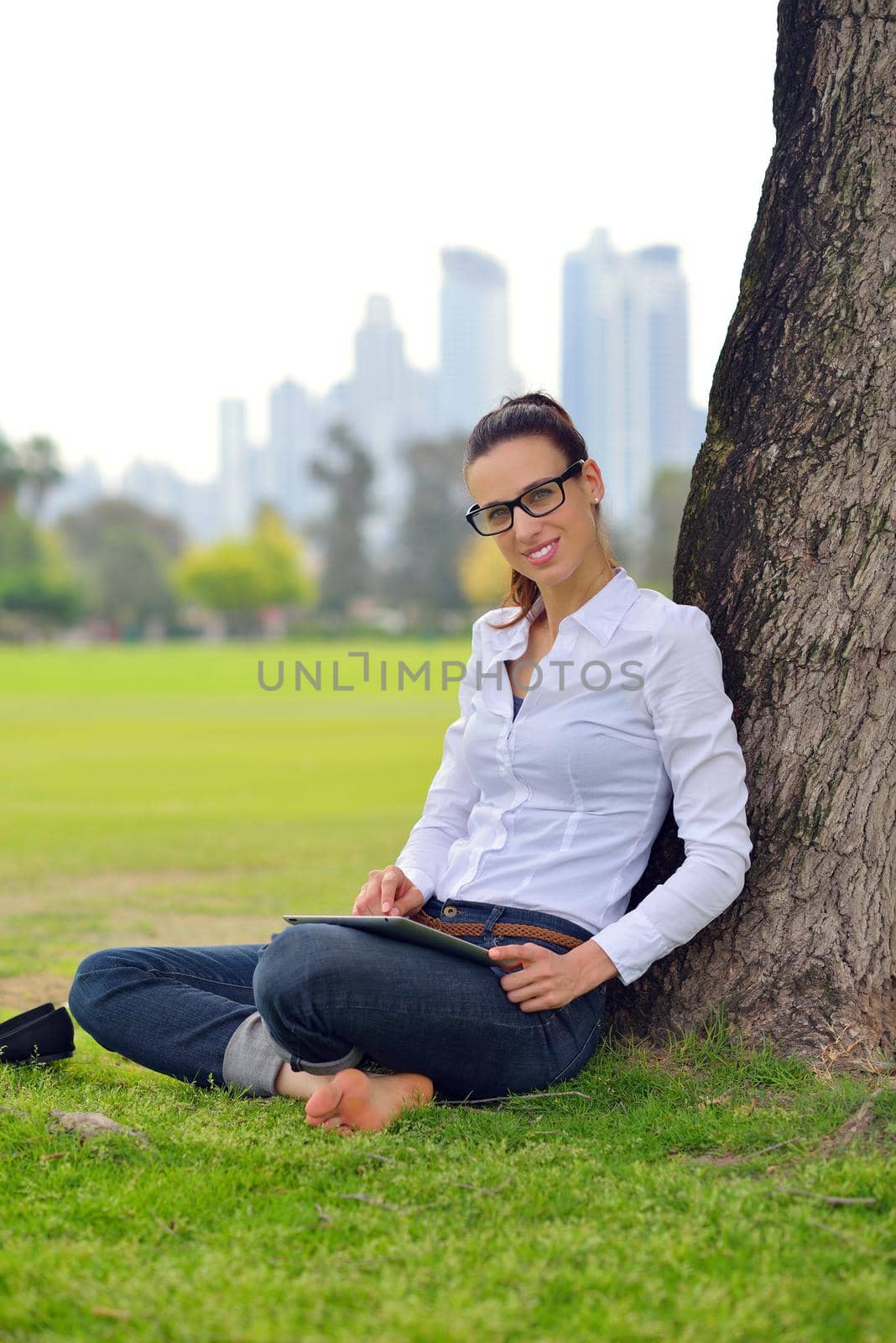 Beautiful young student  woman study with tablet in park