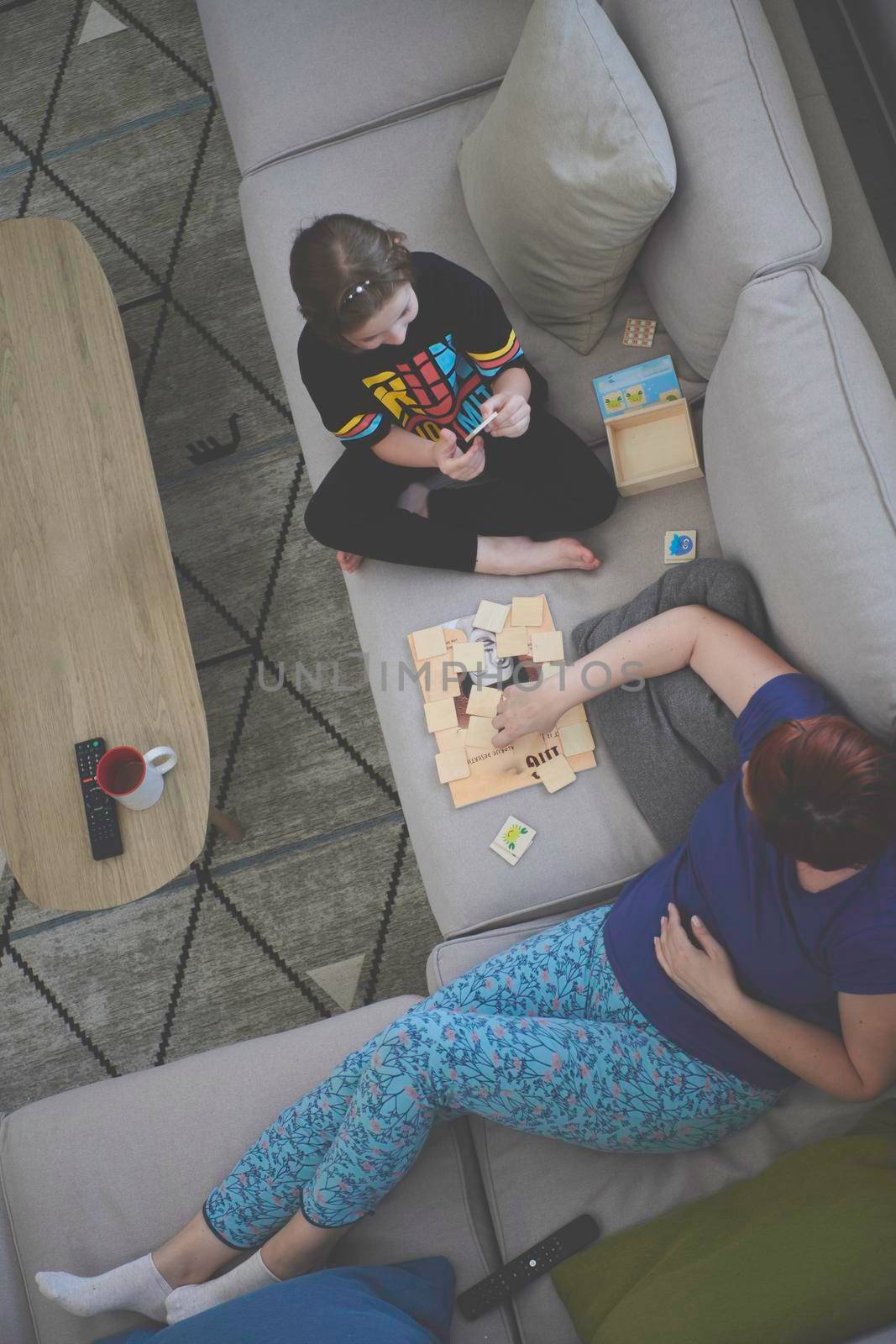 mother and daughter at home playing memory game by dotshock