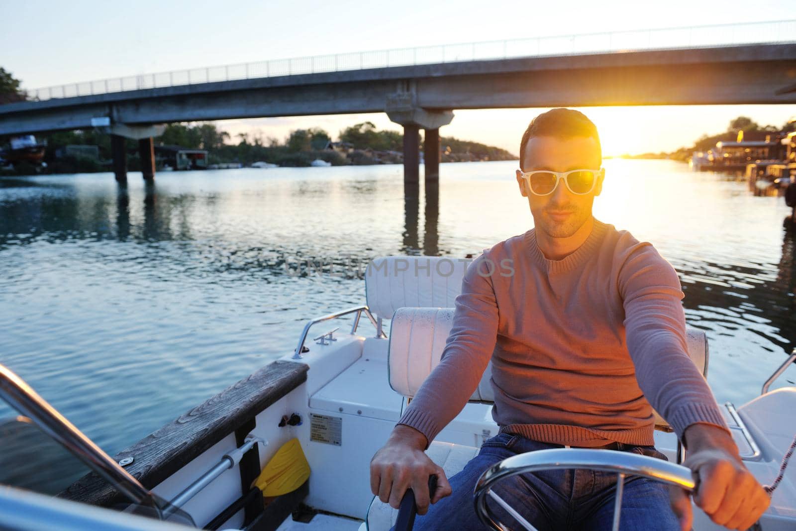 happy young man have fun at boat at sunset on summer season