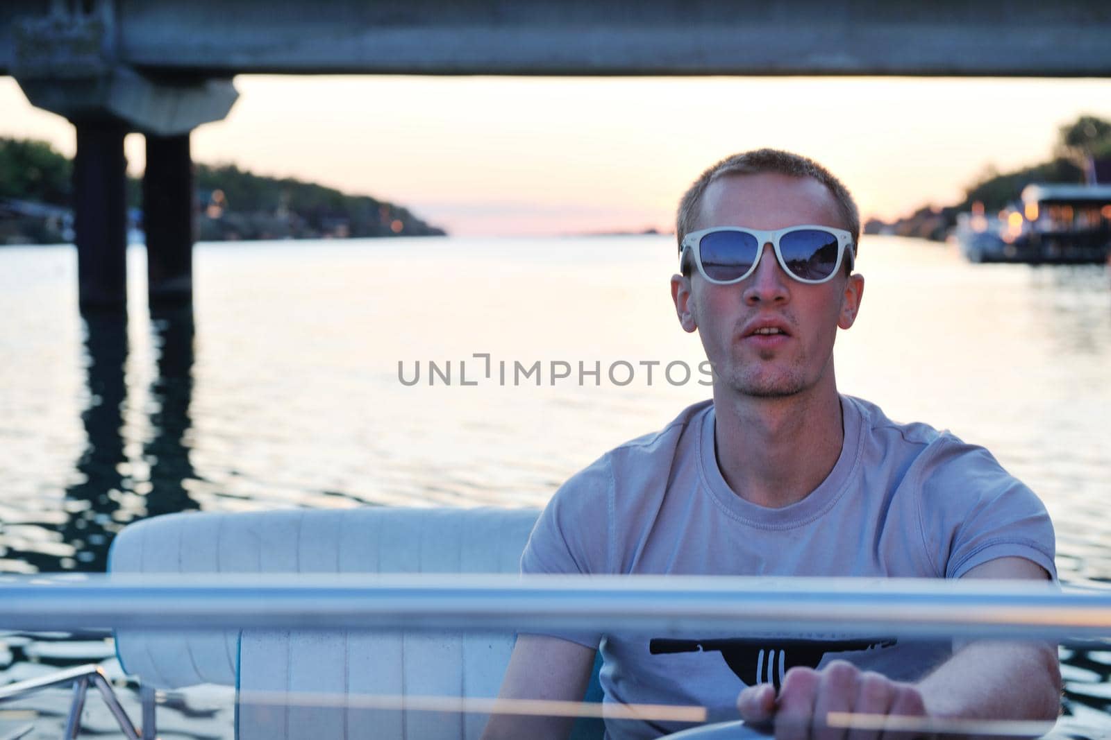 happy young man have fun at boat at sunset on summer season