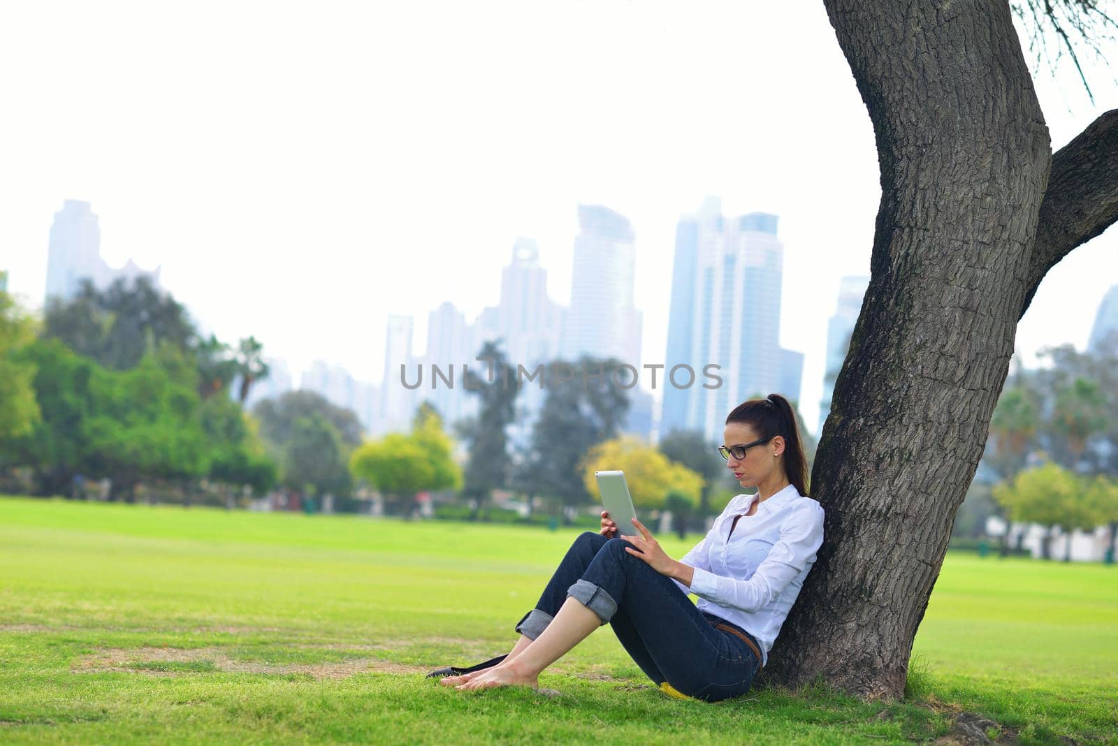 Beautiful young student  woman study with tablet in park