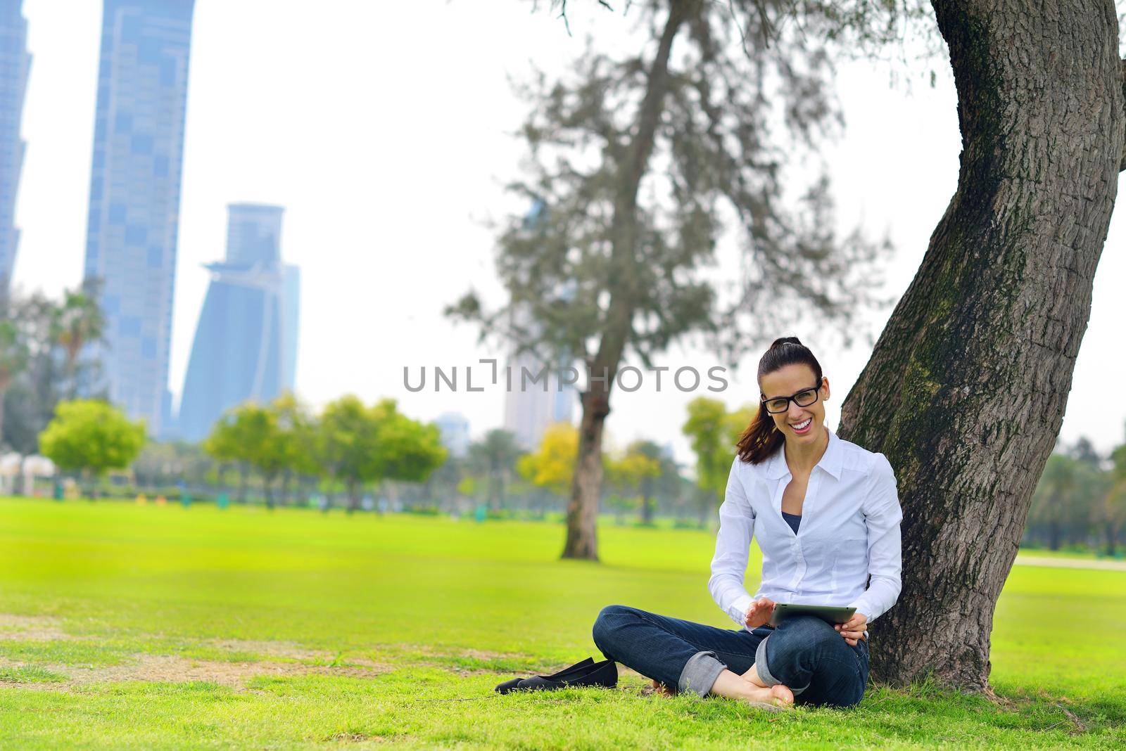 Beautiful young student  woman study with tablet in park