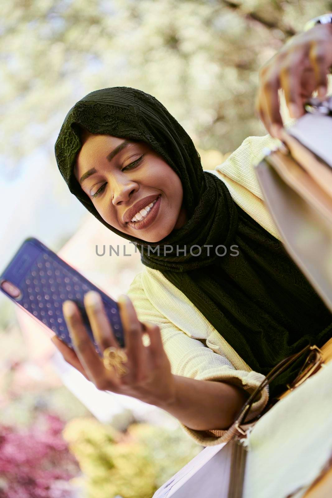 african  business woman using smart phone wearing traditional islamic clothes