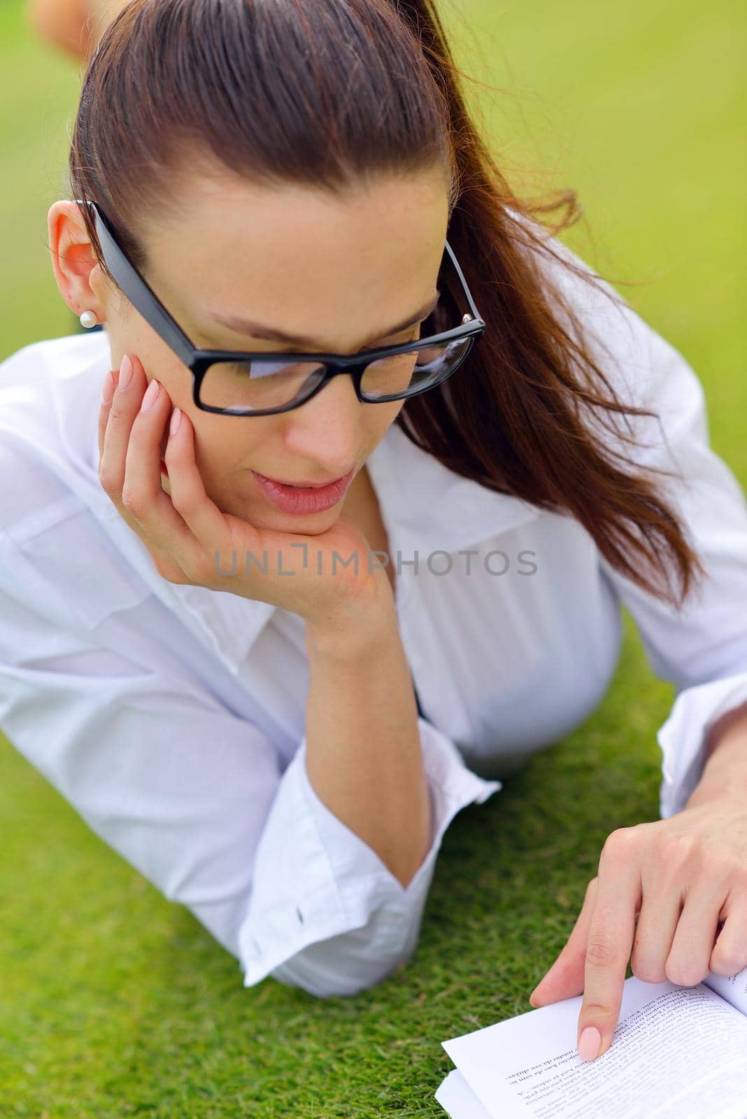 Young student woman reading a book and study in the park