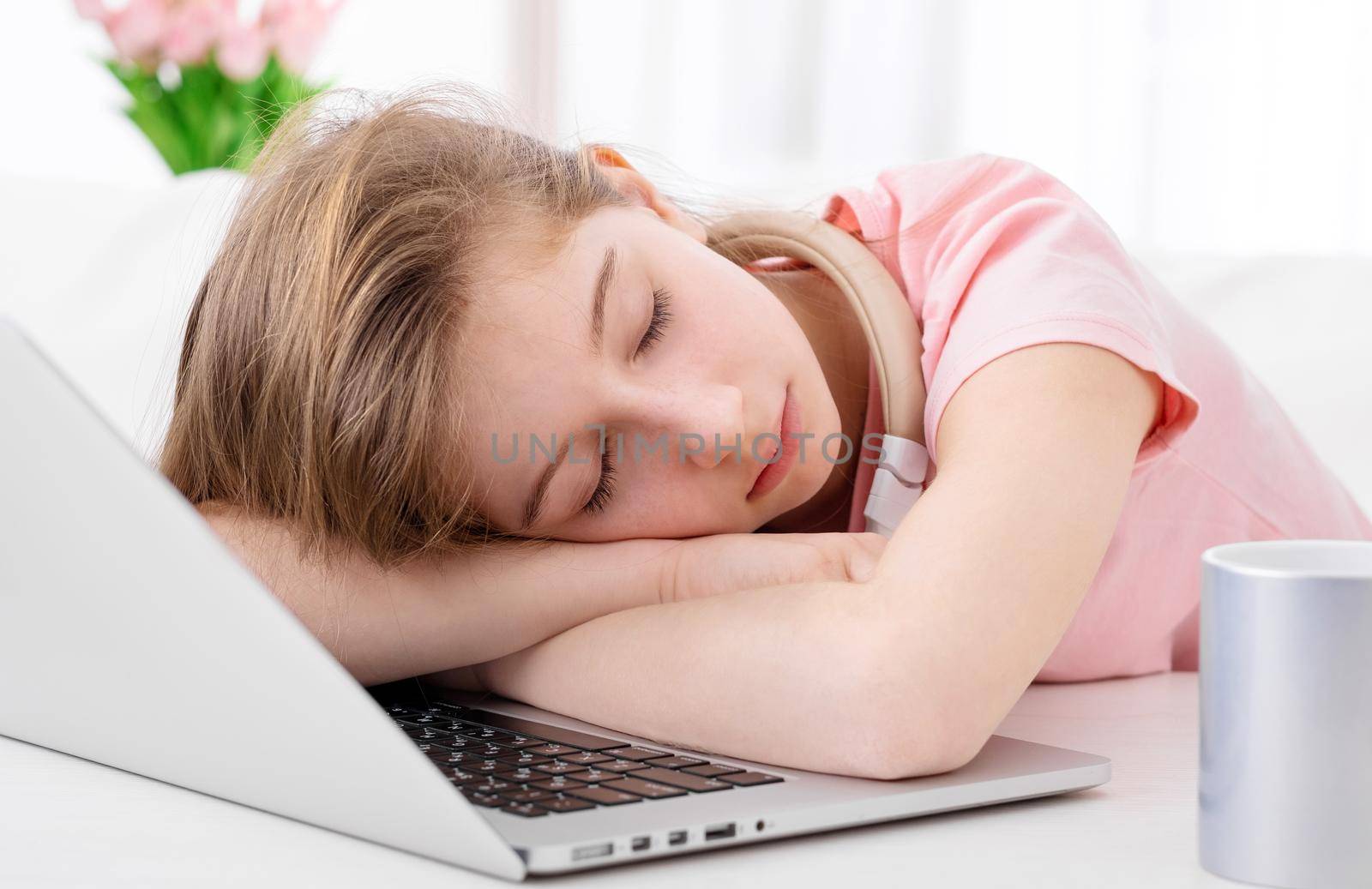 Cute teen fell asleep at desk when working on laptop