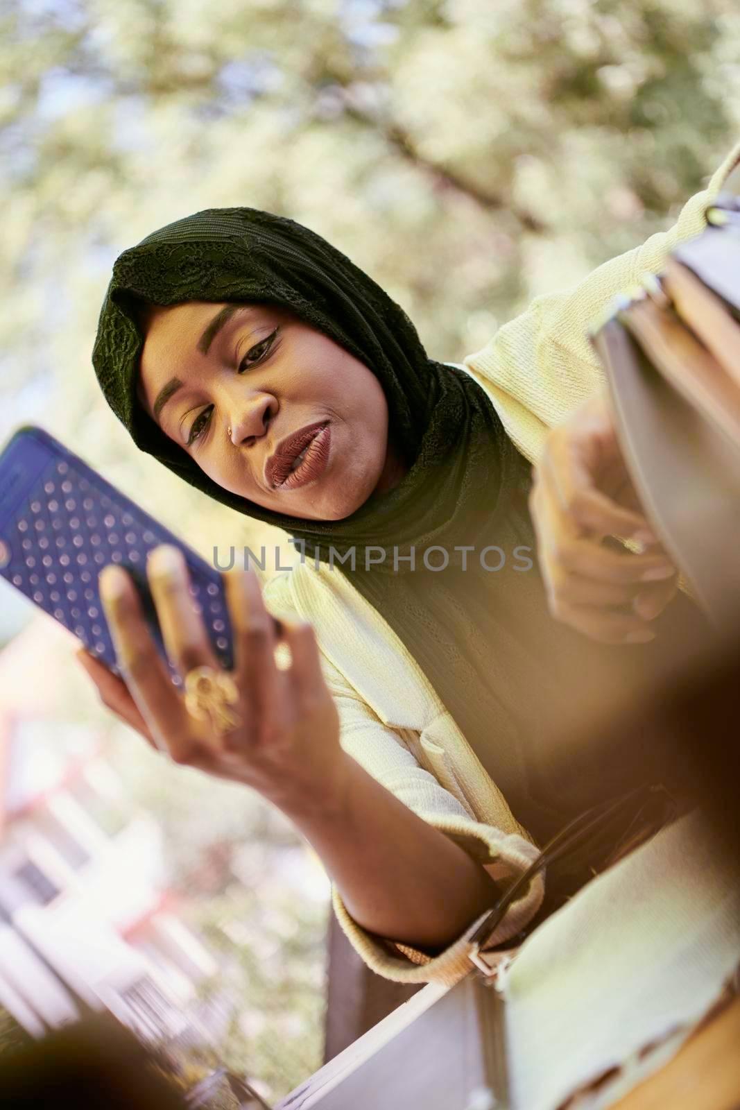 african  business woman using smart phone wearing traditional islamic clothes