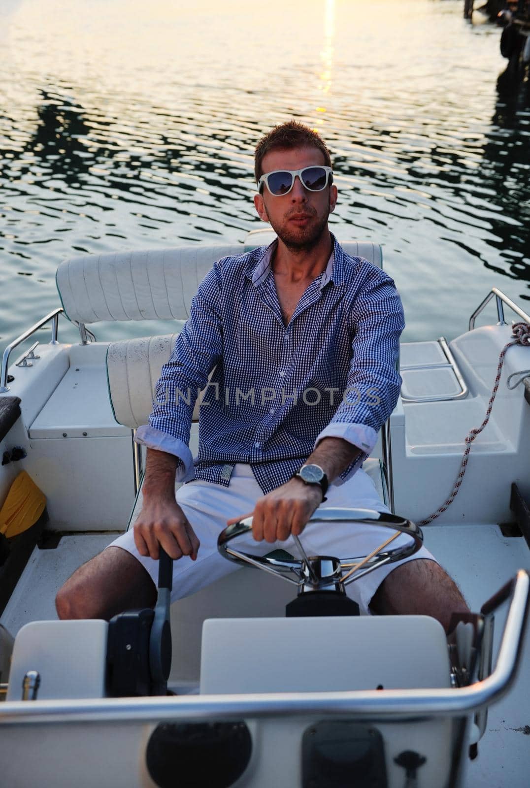 happy young man have fun at boat at sunset on summer season