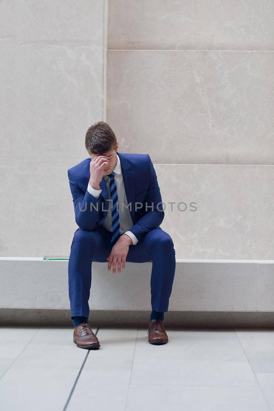 frustrated young business man by dotshock