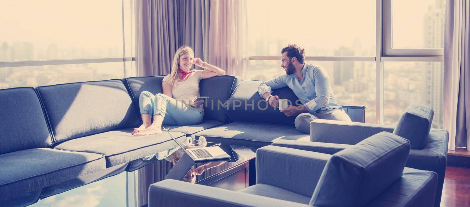 couple relaxing at  home using tablet computer by dotshock