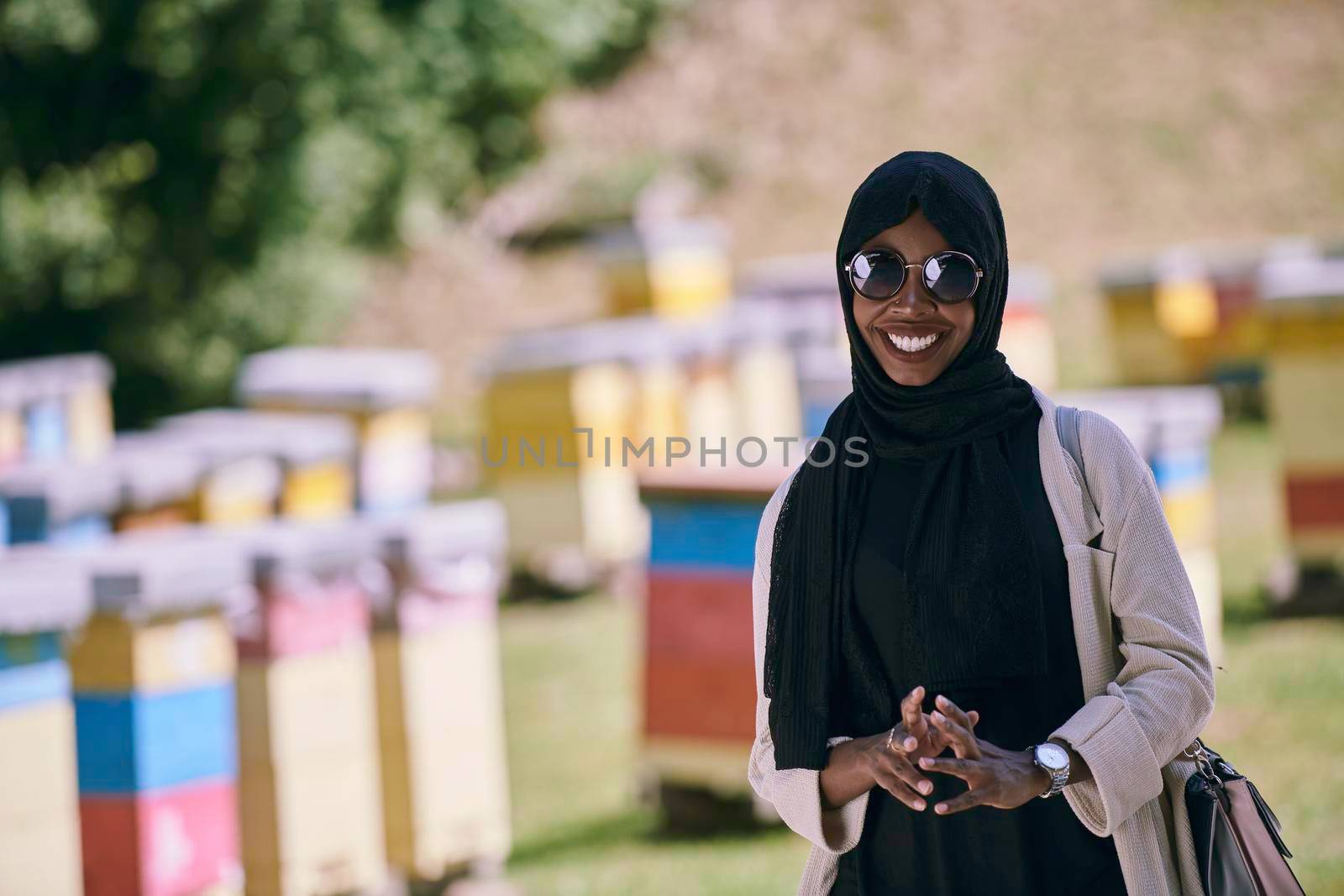 african  muslim businesswoman portrait  on small local  honey production farm by dotshock