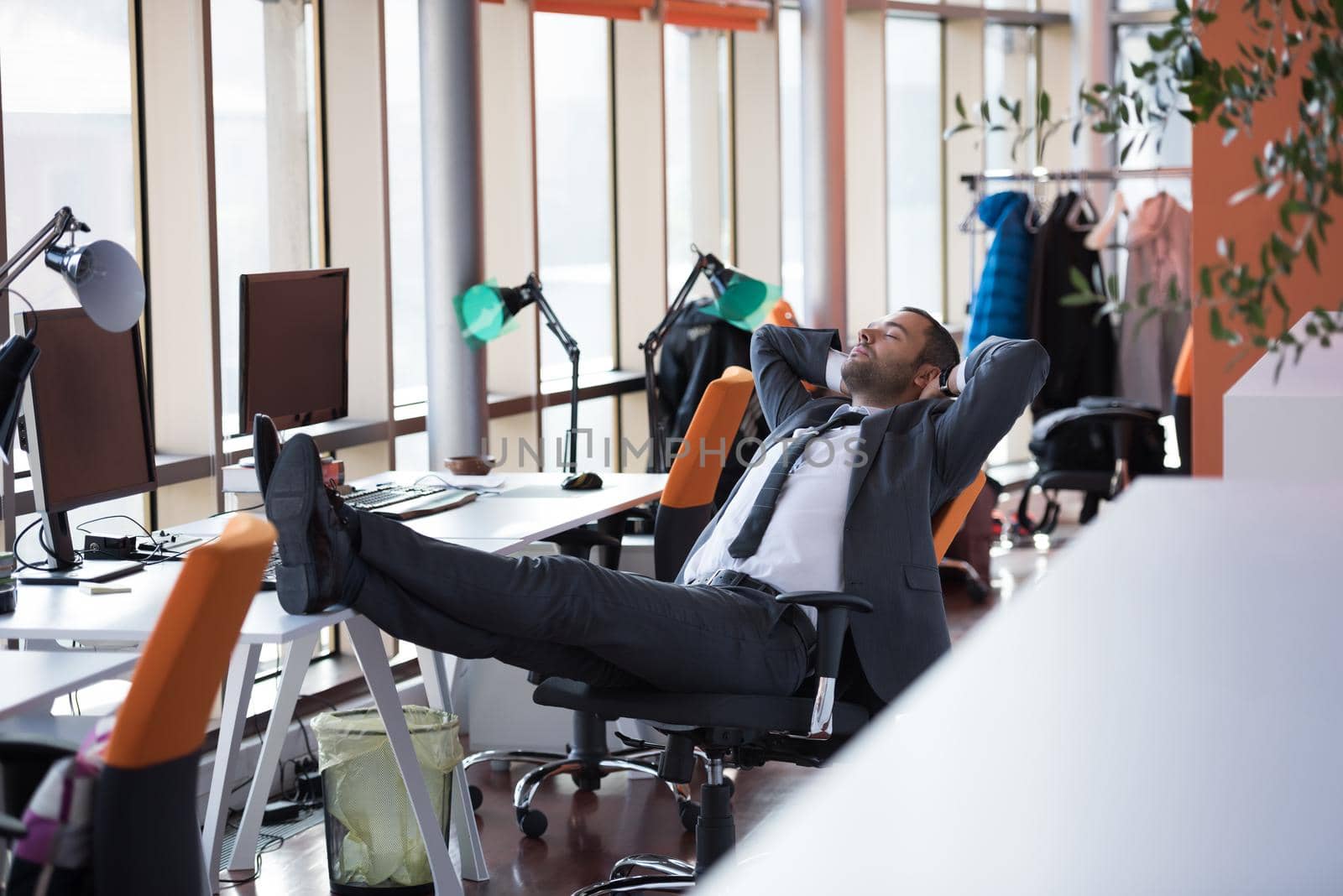 happy young business man portrait in bright modern office indoor