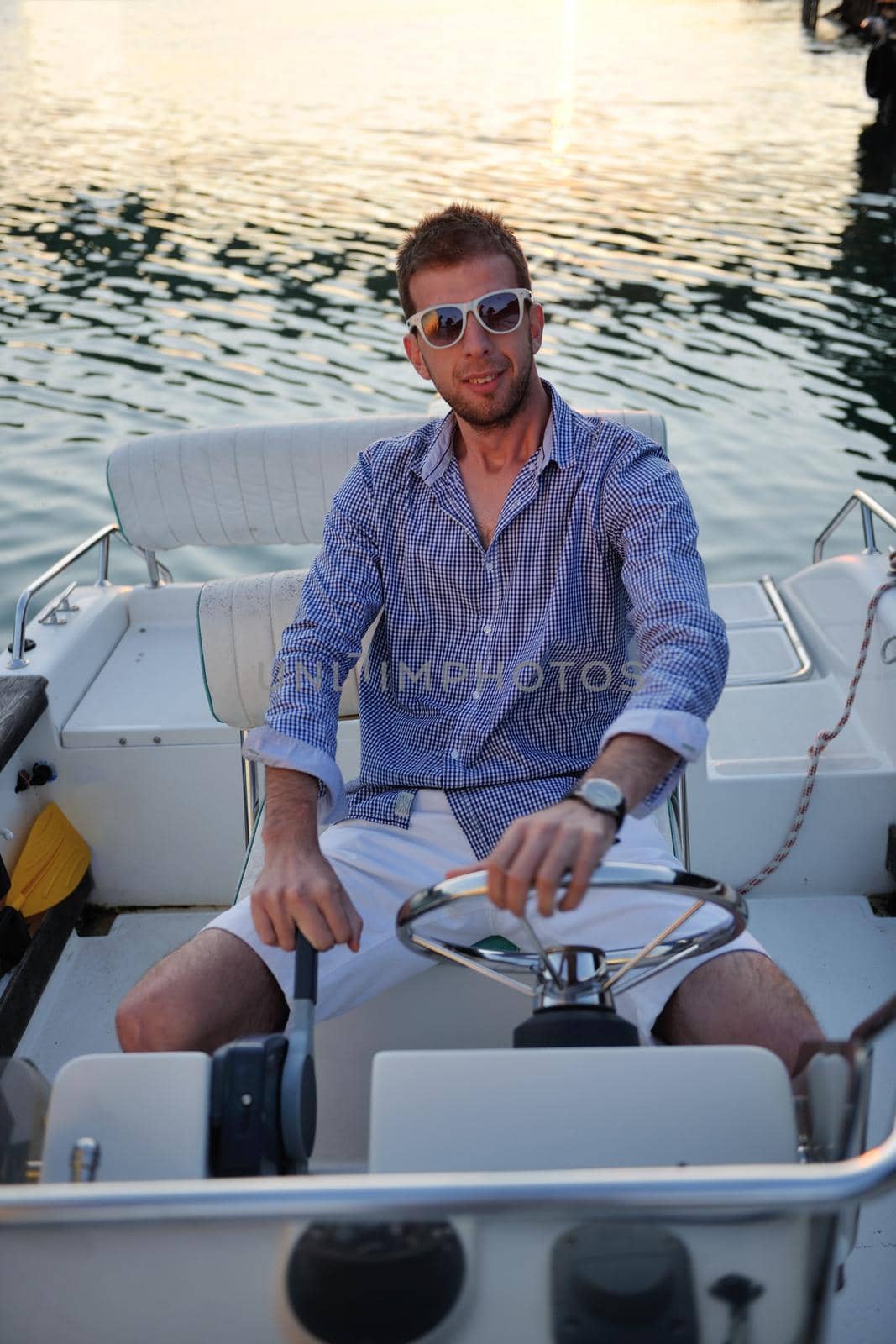 portrait of happy young man on boat by dotshock