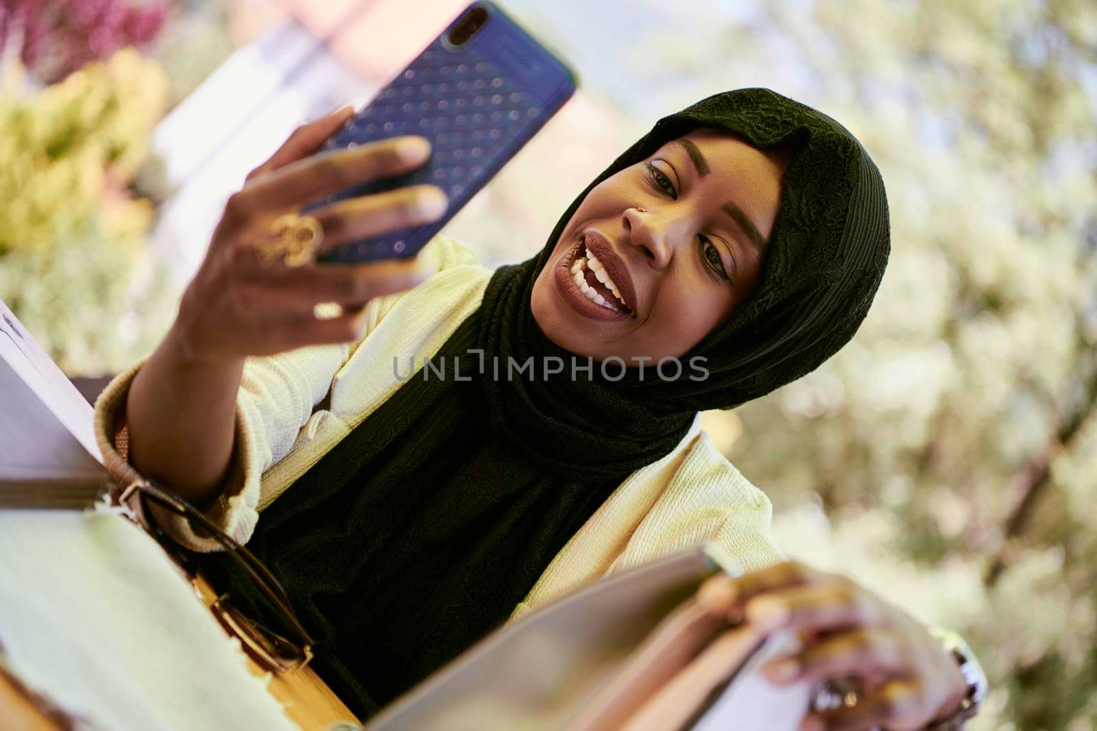 african  business woman using smart phone wearing traditional islamic clothes