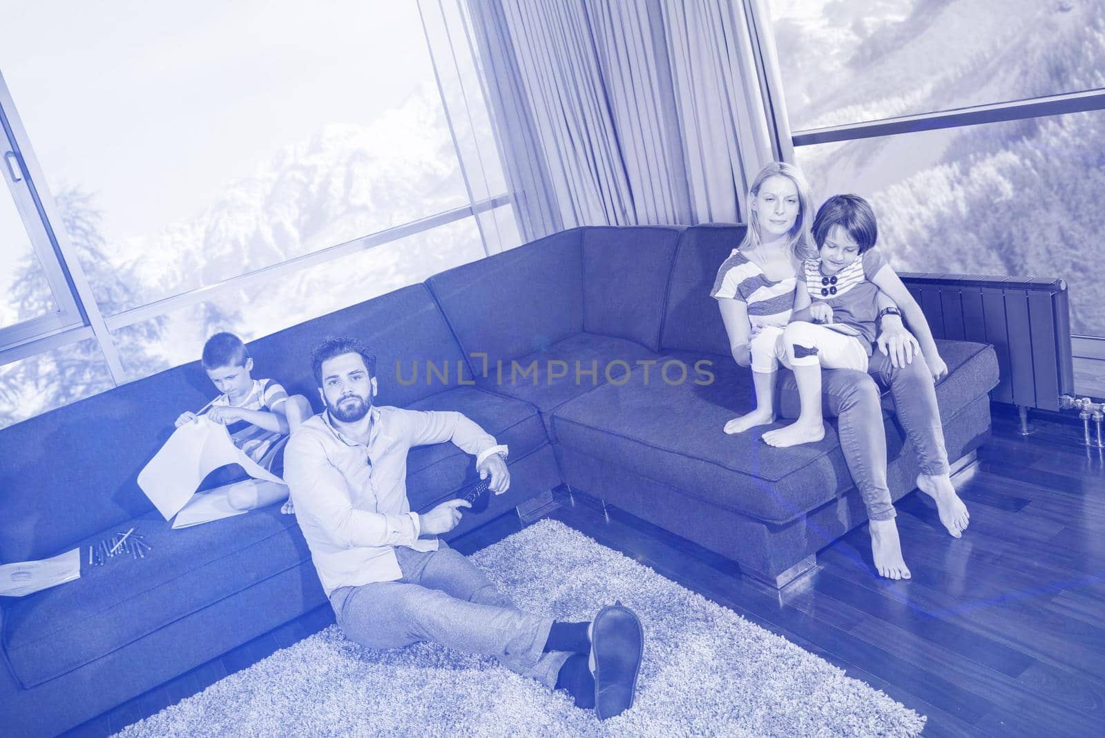 Happy Young Family Playing Together on sofa by dotshock