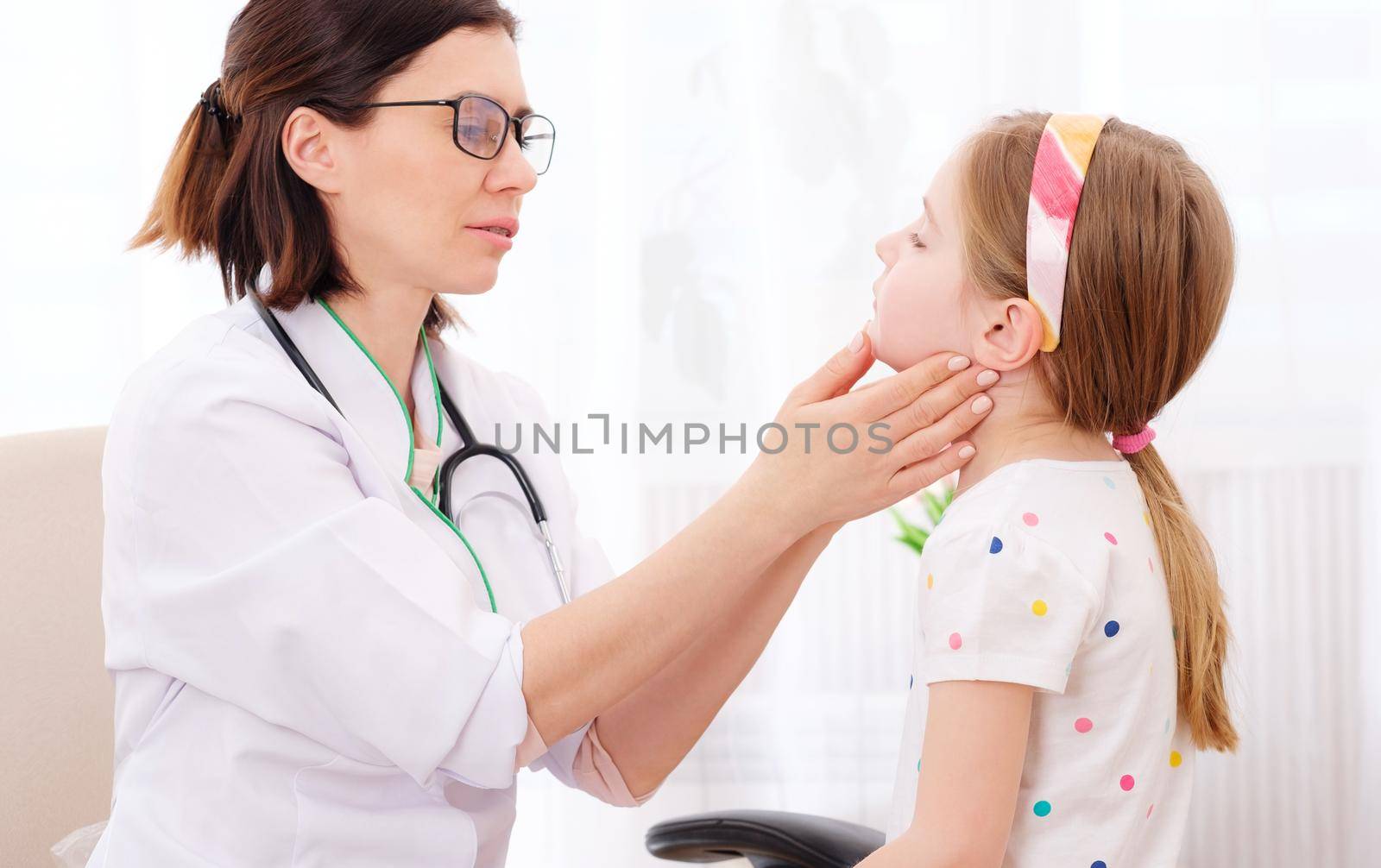 Doctor-physician checking pretty little girls glands