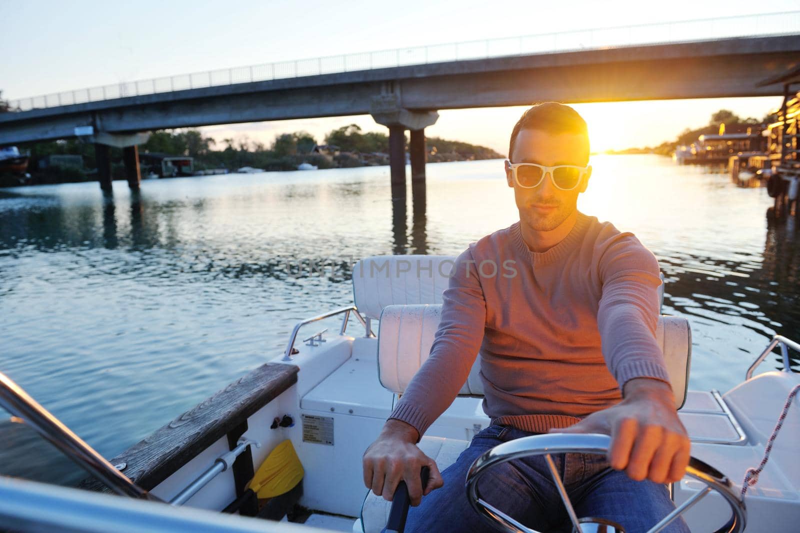 happy young man have fun at boat at sunset on summer season