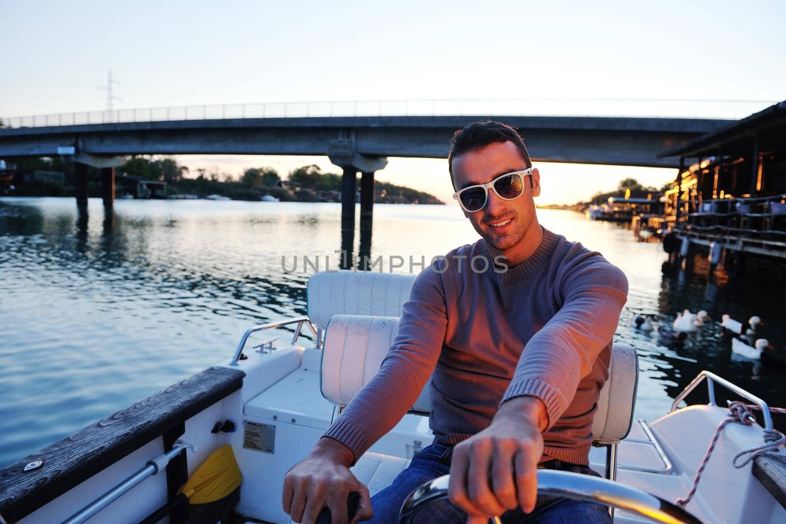 happy young man have fun at boat at sunset on summer season