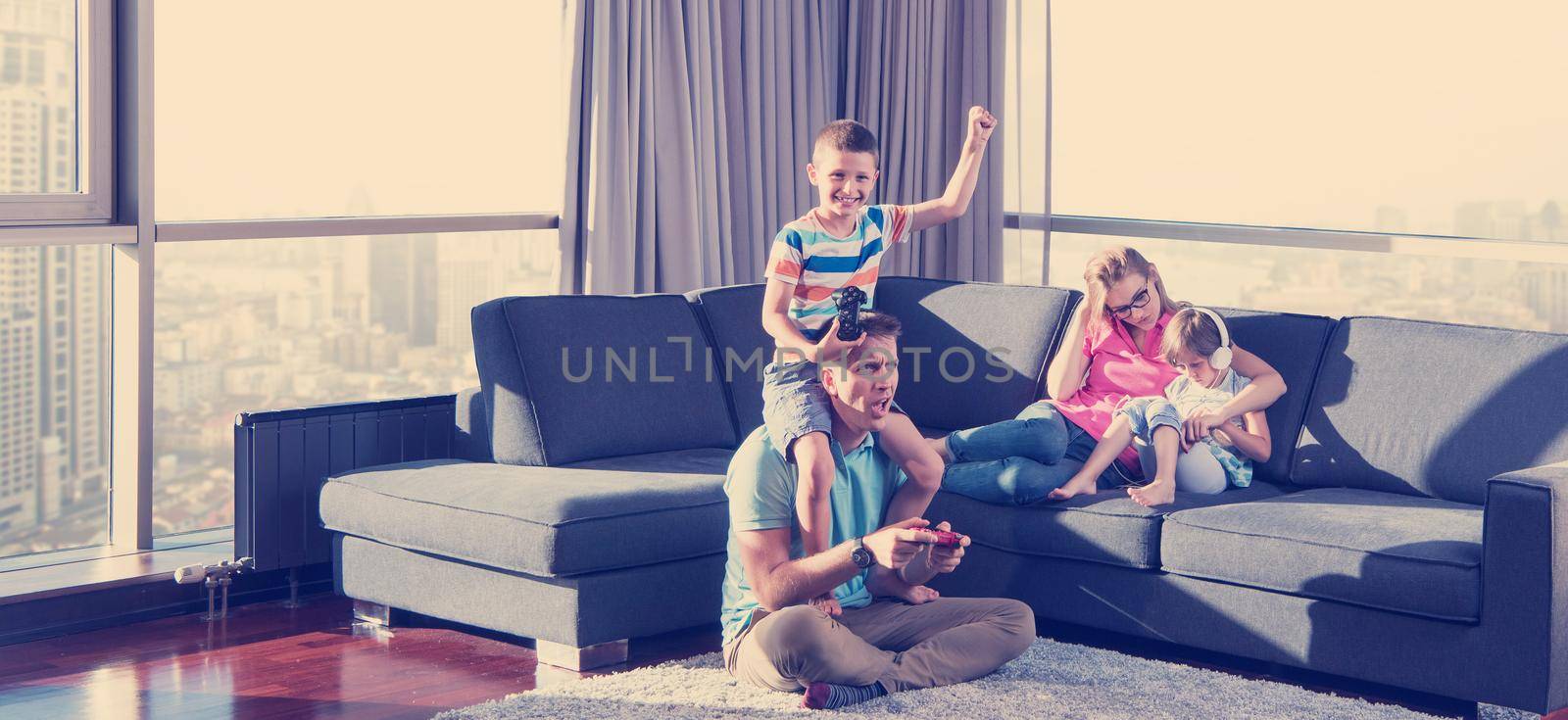 Happy family playing a video game by dotshock