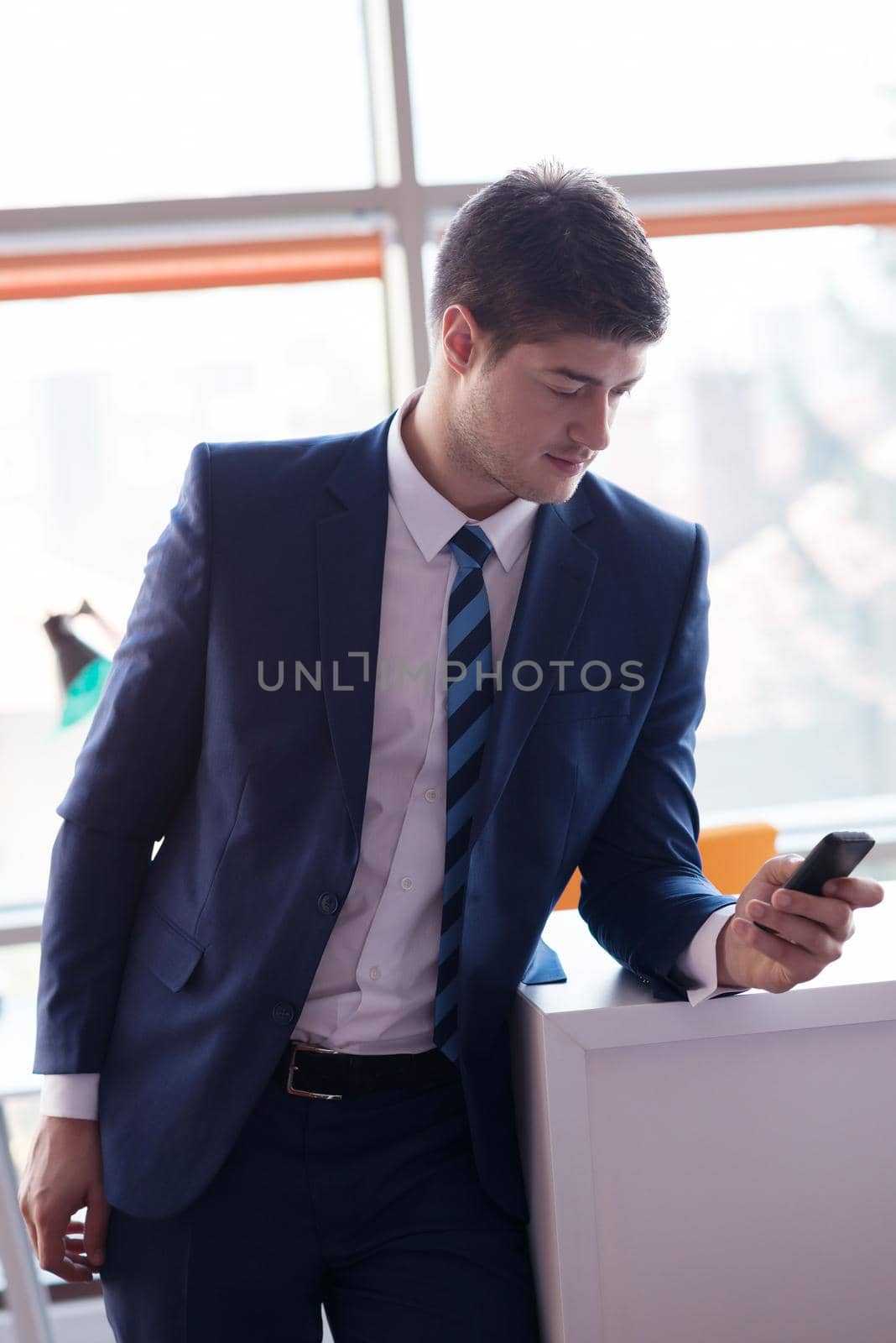 happy young business man portrait in bright modern office indoor