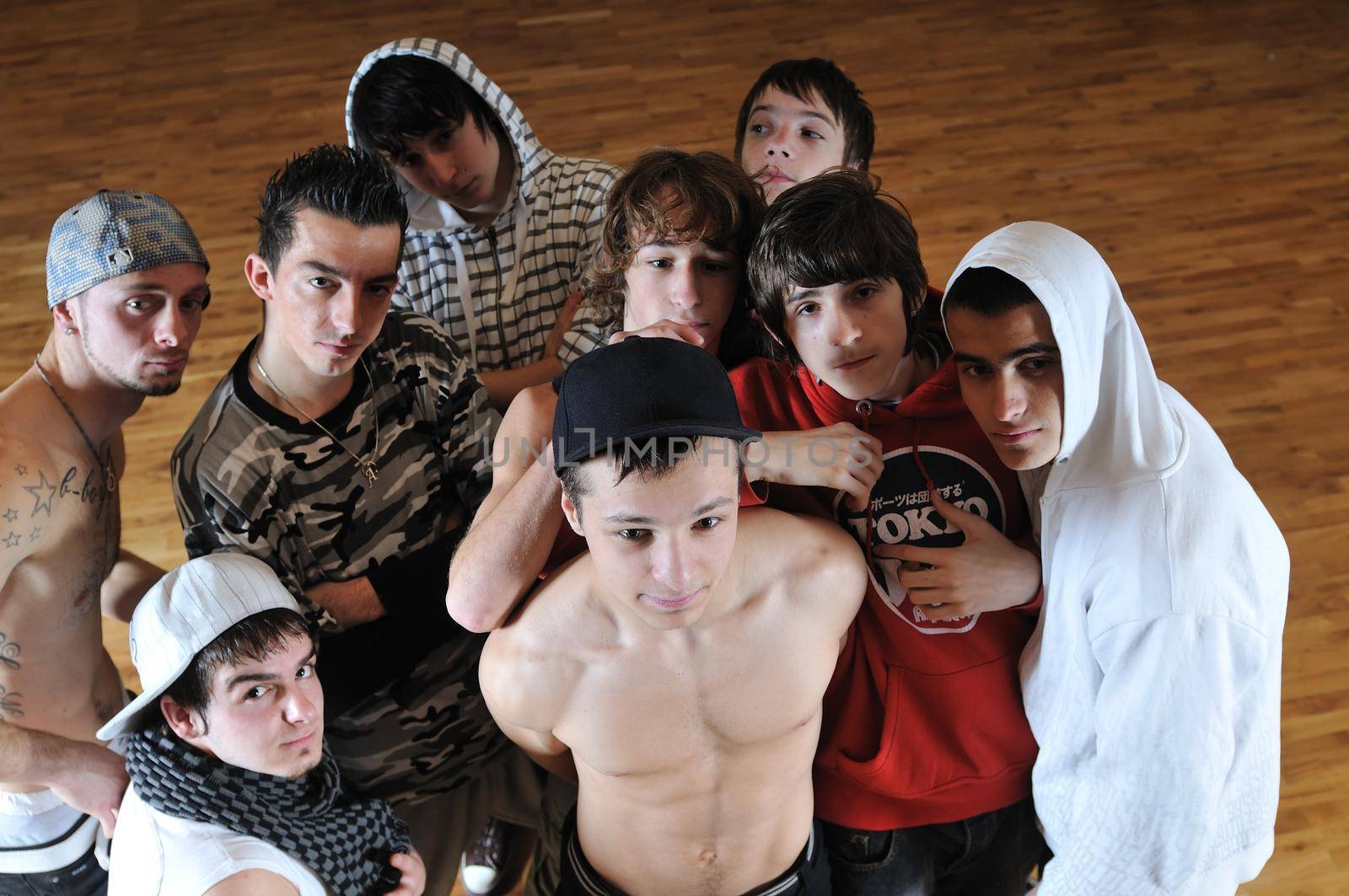 group of young happy boys posing  together in dence studio