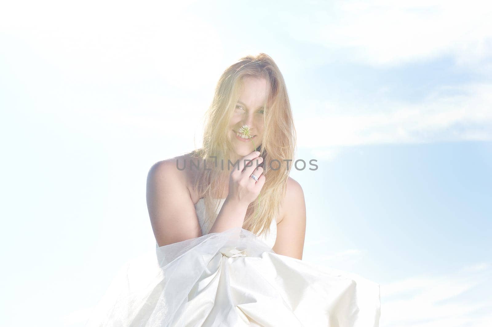 happy young beautiful bride after wedding ceremony event have fun outdoor on meadow at sunset