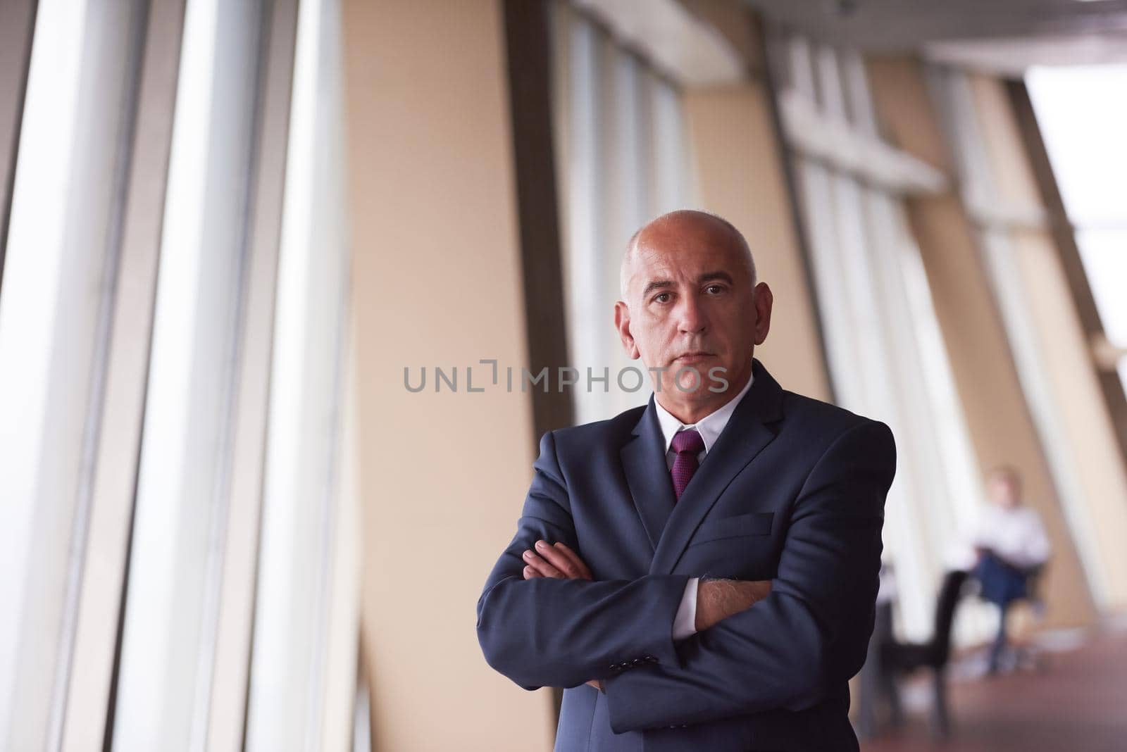 portrait of senior business man alone in modern corporate  office indoors