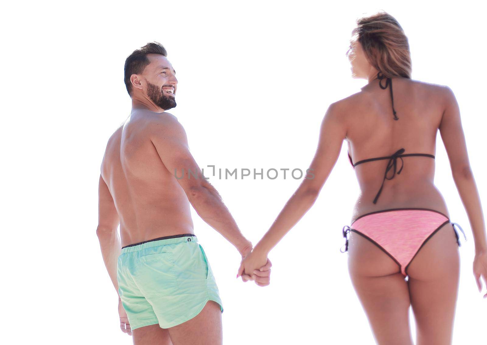 Attractive Fit Couple on the Beach in Swimwear Holding Hands. by asdf