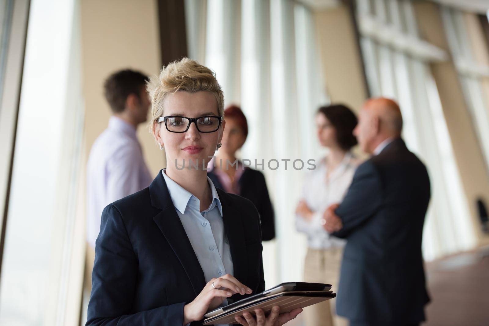 portrait of older business woman  at office with tablet computer by dotshock