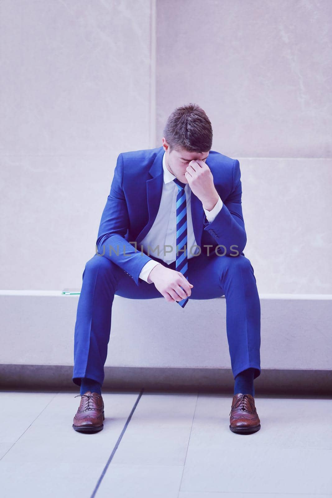 frustrated young business man by dotshock