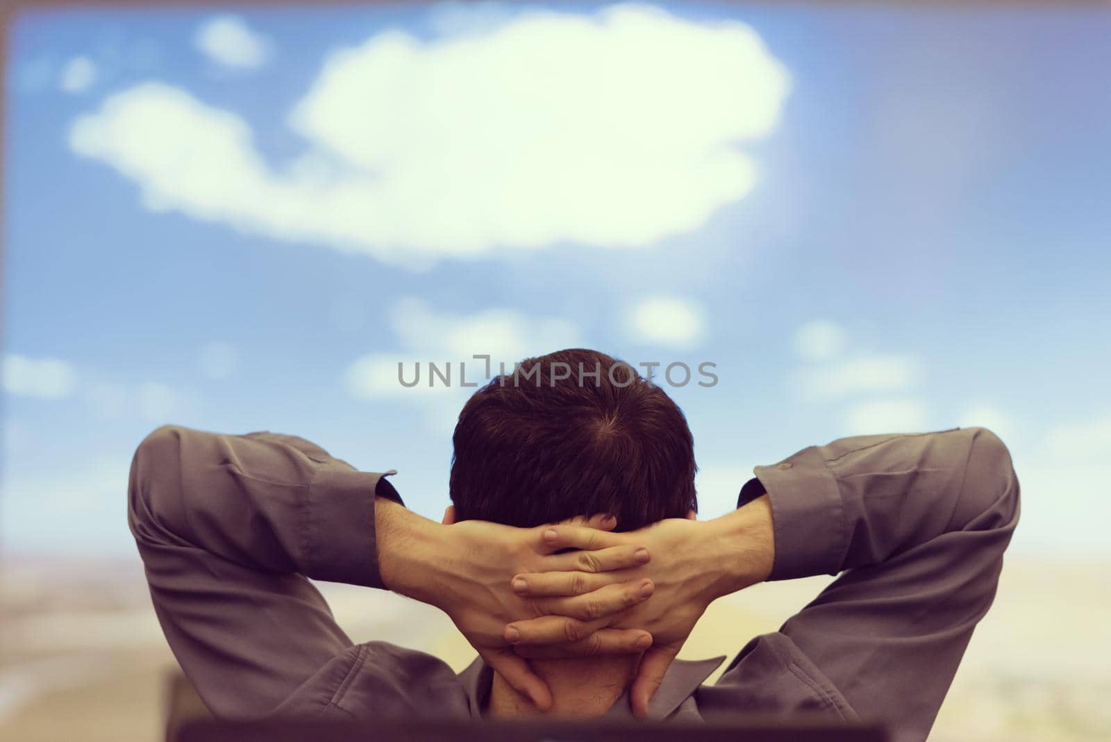 happy  man as audience sitting and relaxing on presentation while looking on beaudiful sky with cloud  and dreaming